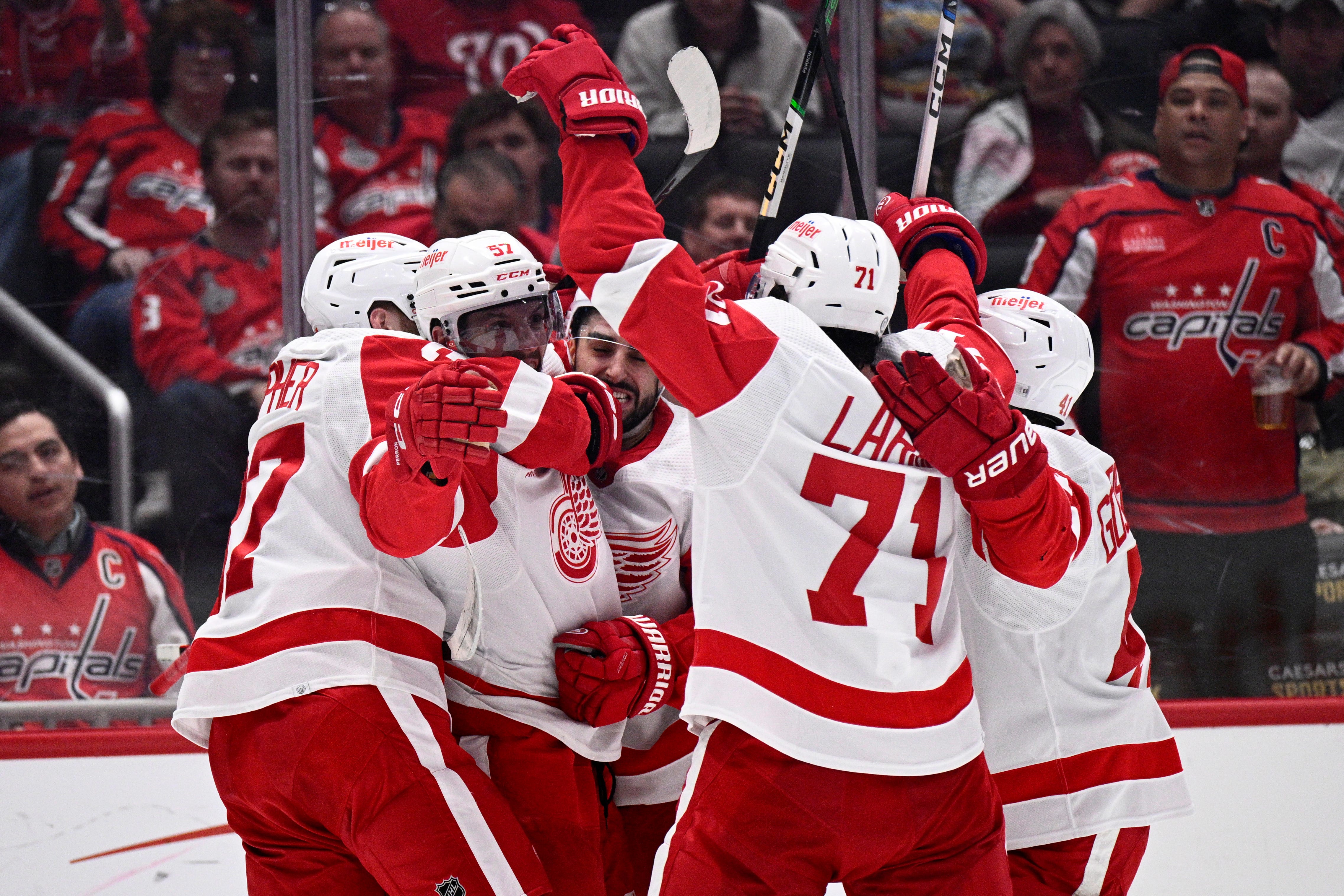 Detroit Red Wings left wing David Perron (57) celebrates his goal with center Dylan Larkin (71), left wing J.T. Compher, left, and others during the second period.