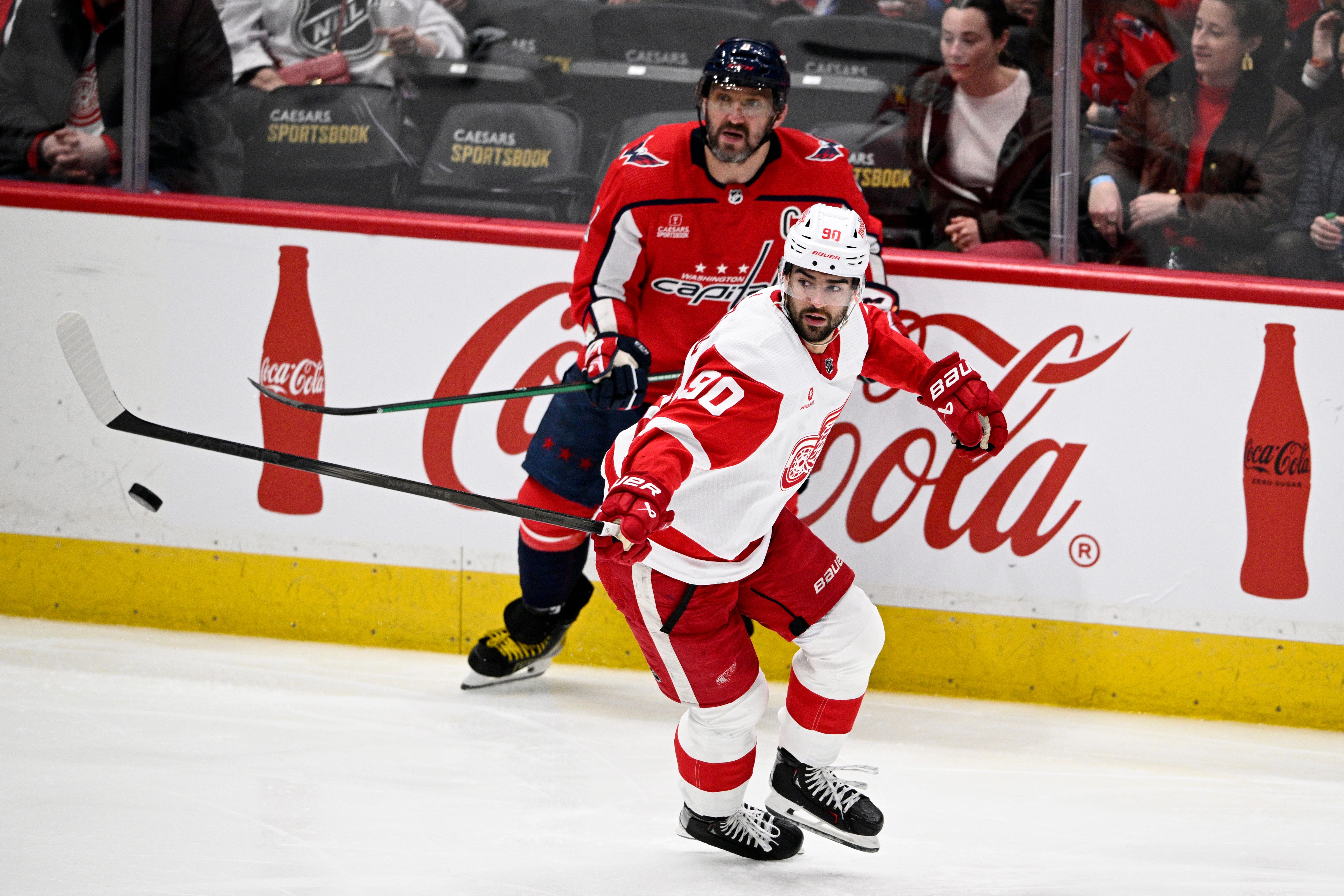 Detroit Red Wings center Joe Veleno (90) reaches for the puck in front of Washington Capitals left wing Alex Ovechkin (8) during the third period.