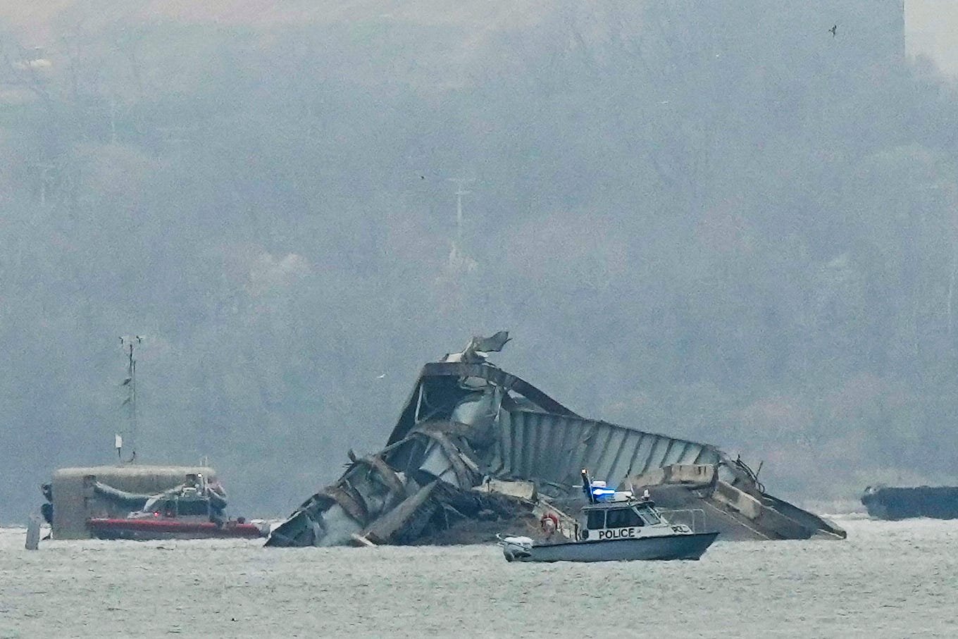 Boats work near wreckage of the Francis Scott Key Bridge on Wednesday, March 27, 2024, in Baltimore, Md.