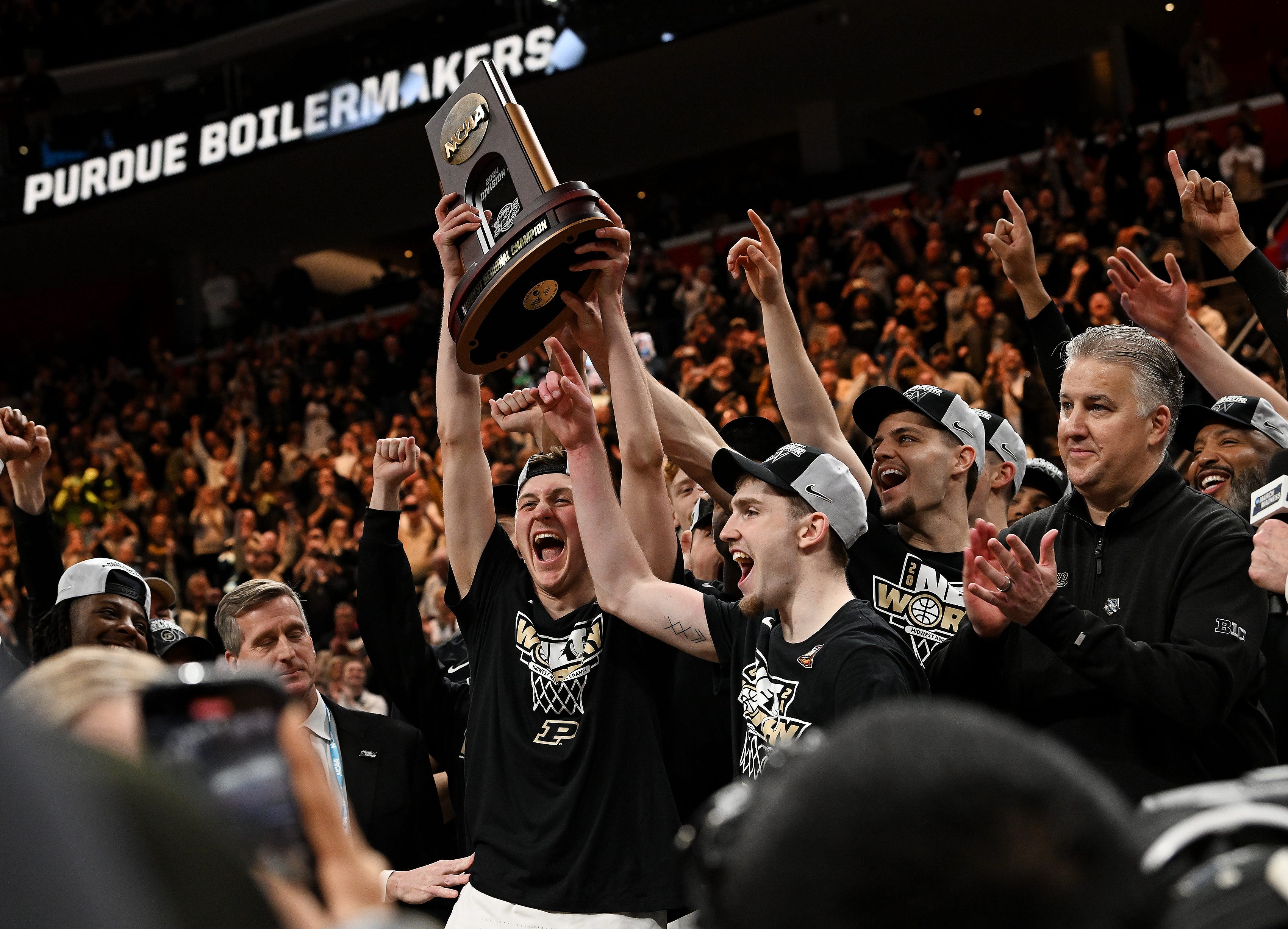 Purdue guards Fletcher Loyer, Braden Smith and head coach Matt Painter celebrate after their 72-66 win over Tennessee in the NCAA Midwest Regional Semifinal at Little Caesars Arena in Detroit on Mar. 31, 2024.