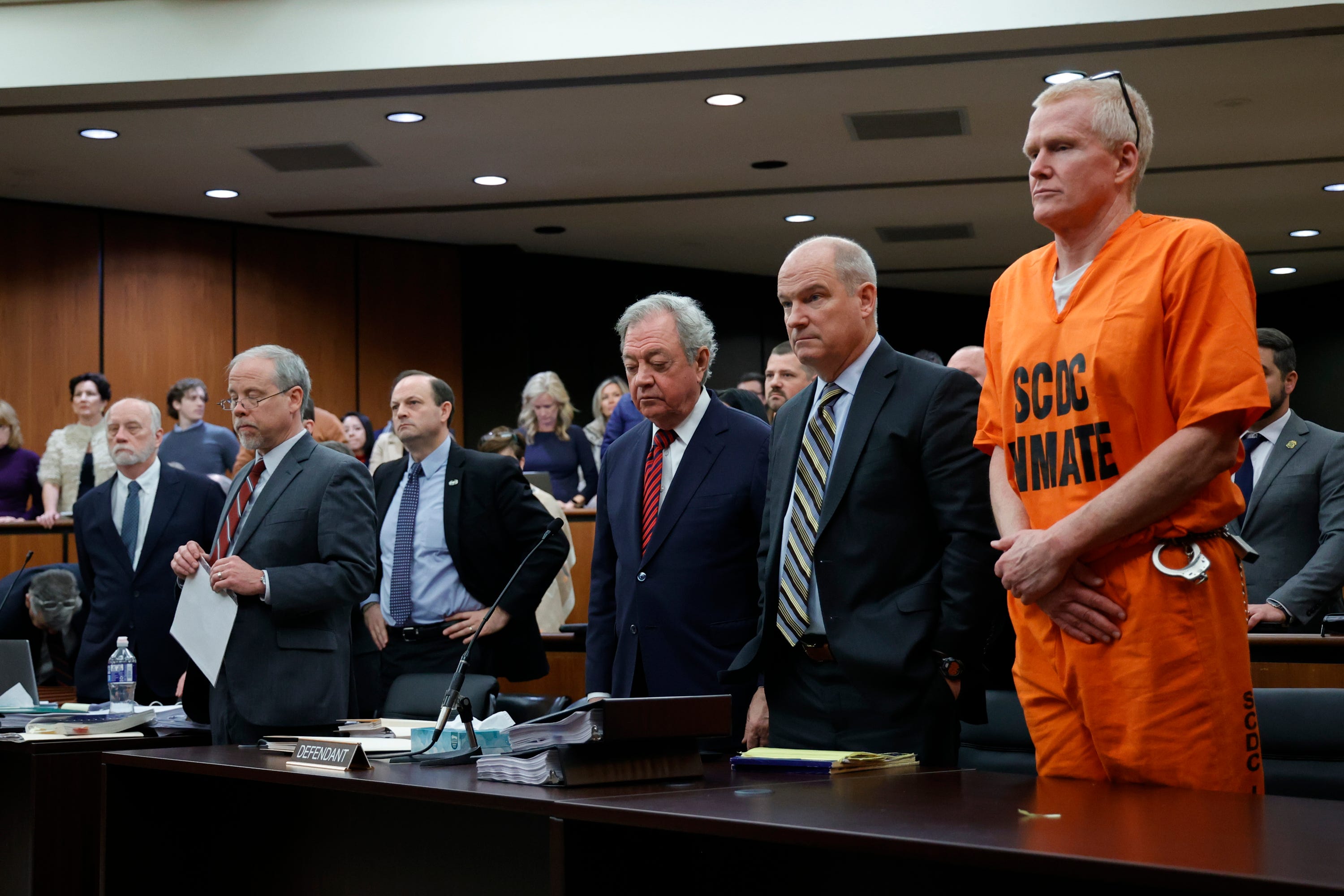 Alex Murdaugh, convicted of killing his wife, Maggie, and younger son, Paul, in June 2021, stands with his defense team during a hearing on a motion for a retrial, Jan. 16, 2024, at the Richland County Judicial Center in Columbia, S.C.