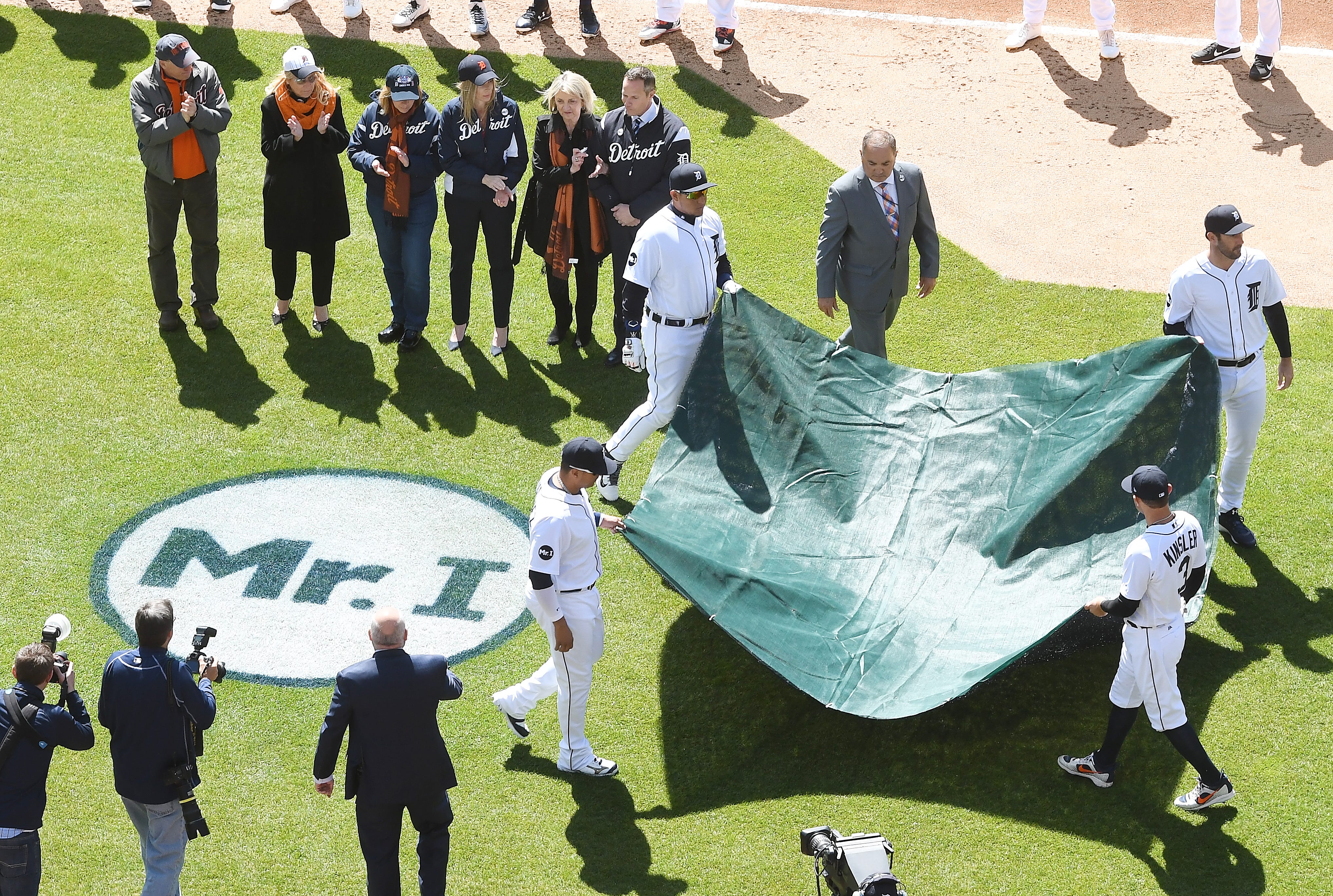 Detroit Tigers players Victor Martinez, Miguel Cabrera, Justin Verlander and Ian Kinsler remove the tarp off of the 'Mr I' logo in front of the Tigers bench to commemorate owner Mike Ilitch, who passed during the offseason, with wife Marian Ilitch and members of the family looking on. MLB Detroit Tigers opening day against the Boston Red Sox at Comerica Park in Detroit, Michigan on April 7, 2017.