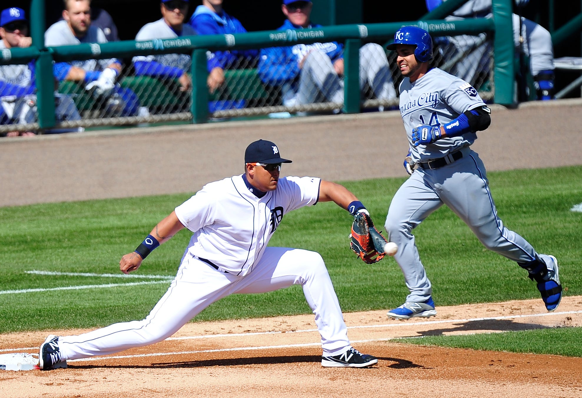 Tigers Miguel Cabrera stretches out for an out on Royals and former Tigers Omar Infante in the first inning during Tigers Opening Day vs the Kansas City Royal at Comerica Park in Detroit, Michigan on March 31, 2014.
