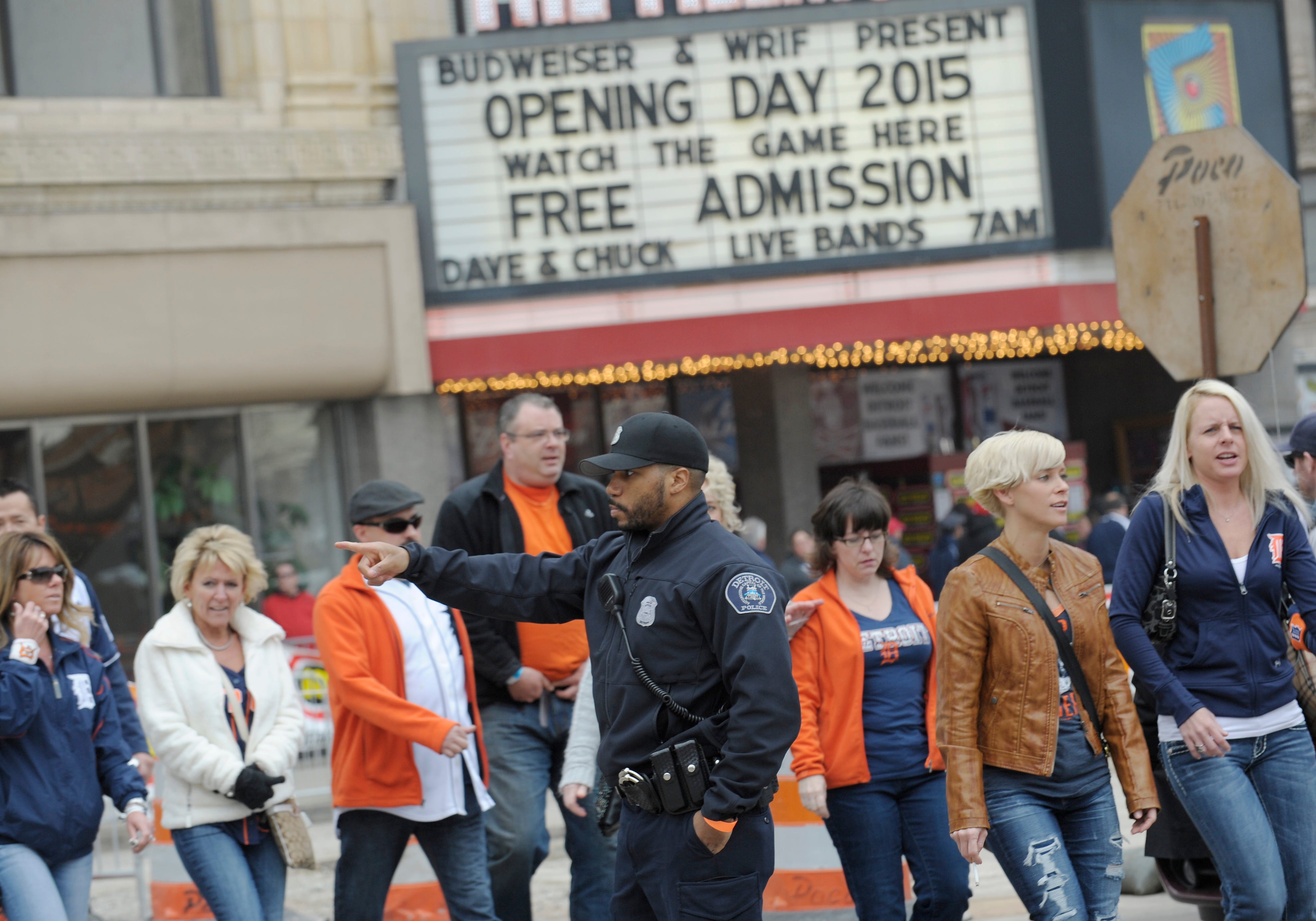 Maurice Alexander of the Detroit Police Dept. directs traffic on Woodward Ave. at Elizabeth St. Detroit Tigers Opening Day at Comerica Park, Detroit, MI.