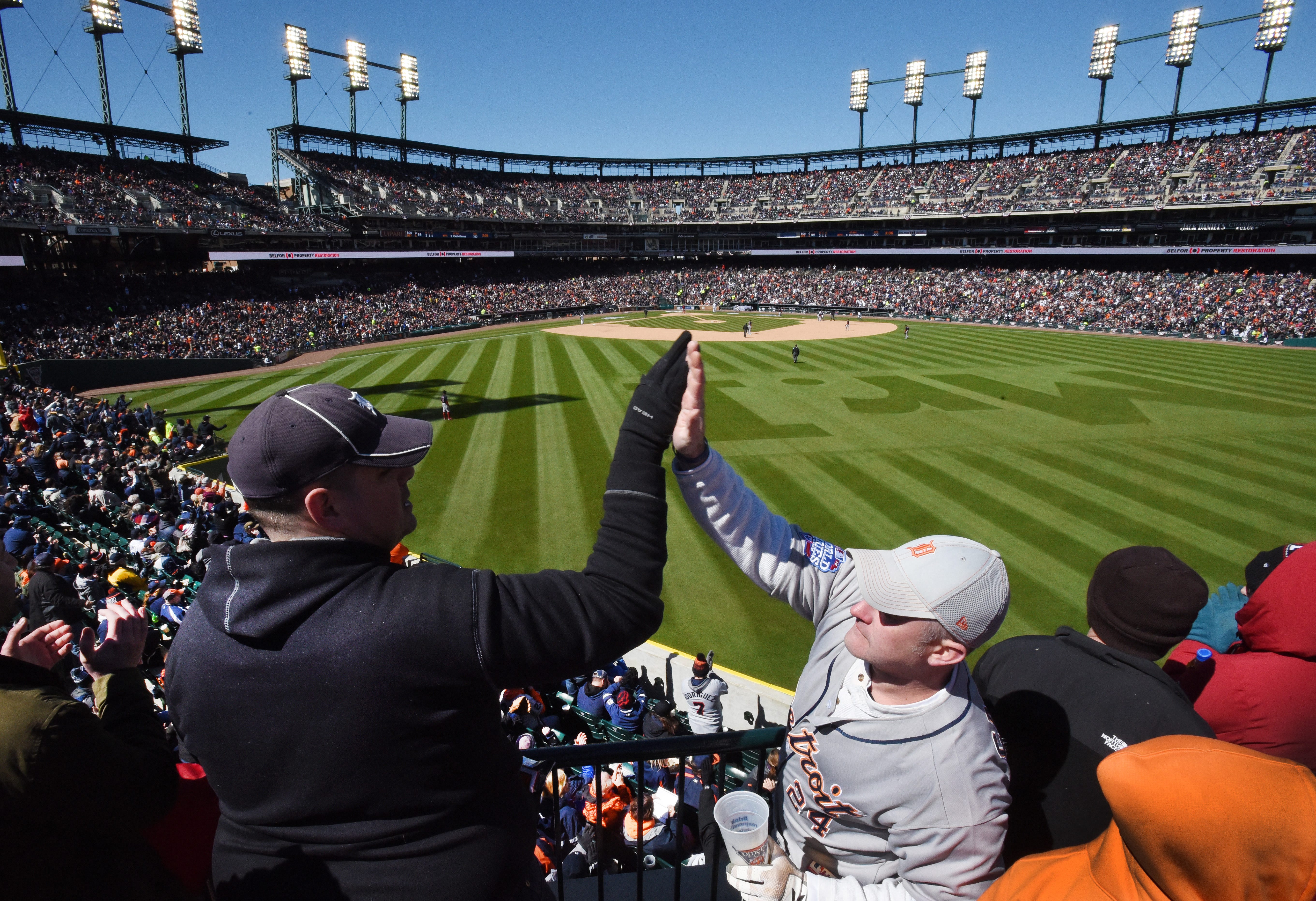 Tom Renner and Larry Griffin 'high-5' after a triple by Nick Castellanos in the bottom of the 6th inning. MLB Detroit Tigers opening day against the Boston Red Sox at Comerica Park in Detroit, Michigan on April 7, 2017.