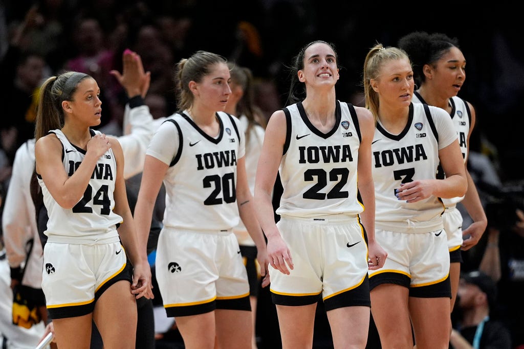 Iowa guard Caitlin Clark (22) reacts after making a three-point basket during the second half of a Final Four college basketball game against UConn in the women's NCAA Tournament on Friday in Cleveland.