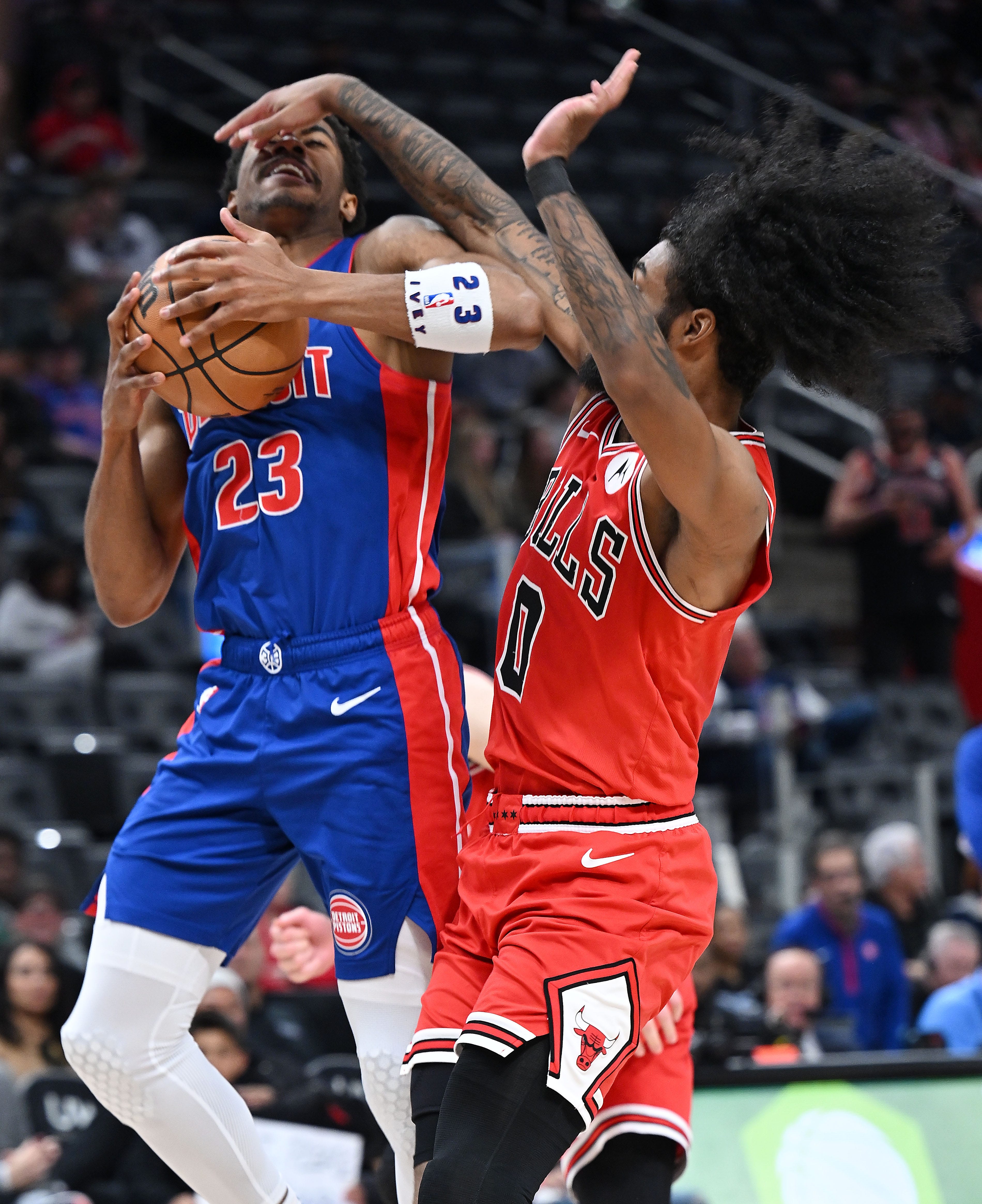Chicago Bulls guard Coby White (0) defends Detroit Pistons guard Jaden Ivey (23) in the third quarter. Detroit Pistons vs Chicago Bulls, Little Caesars Arena, April 11, 2024, in Detroit, MI.