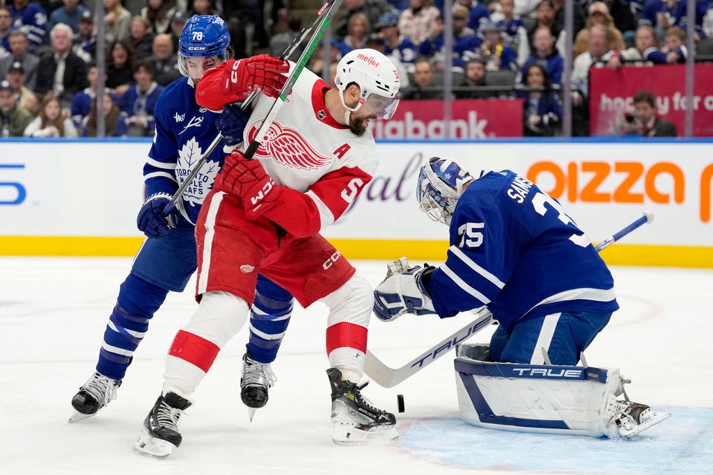 Maple Leafs defenceman TJ Brodie (78) defends as teammate Ilya Samsonov (35) makes a save while Red Wings left wing David Perron (57) looks for the rebound during the third period.
