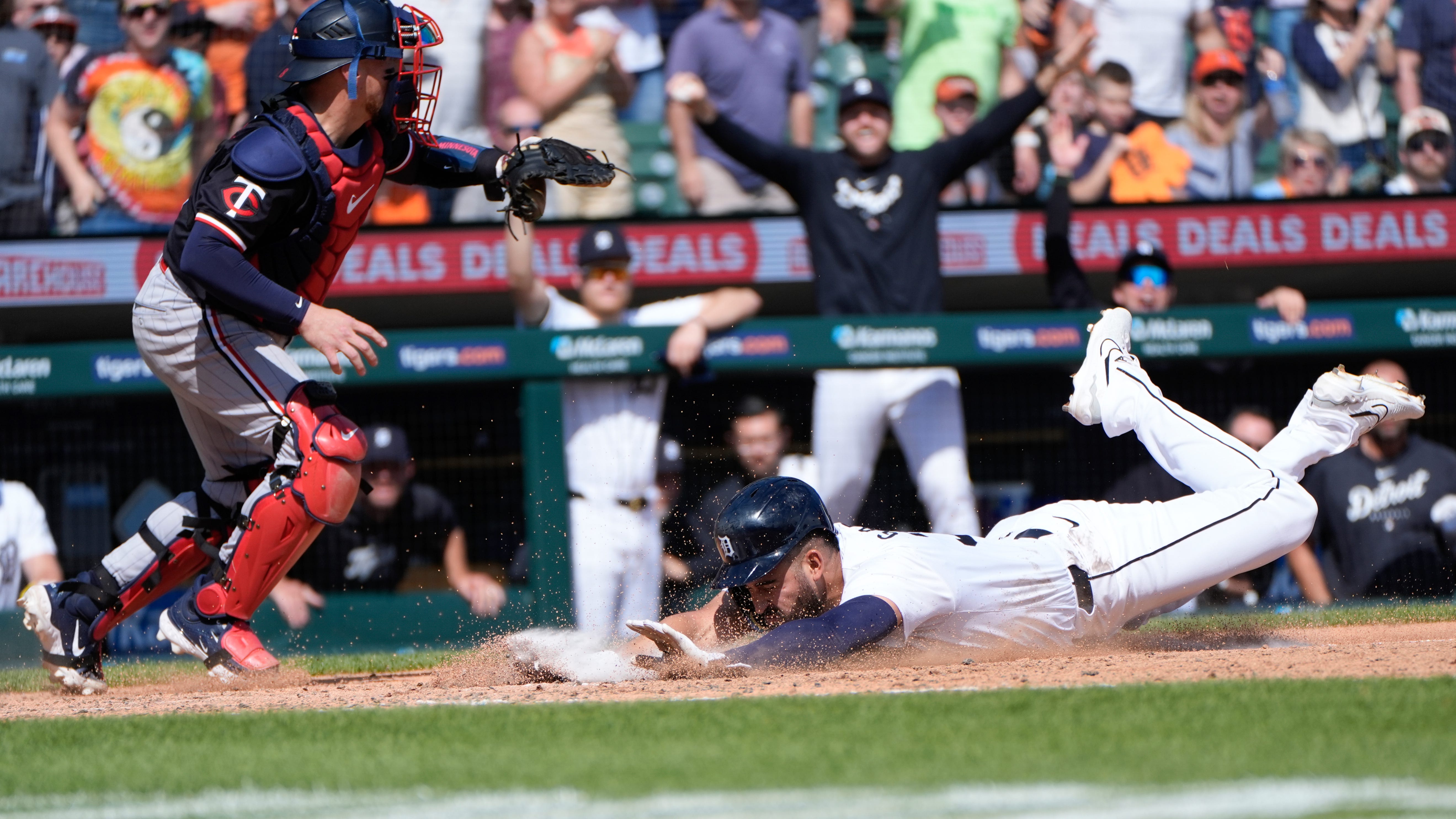 Detroit Tigers' Riley Greene (31) scores as Minnesota Twins catcher Christian Vázquez (8) waits for the throw in the eighth inning of a baseball game, Sunday, April 14, 2024, in Detroit. (AP Photo/Paul Sancya)