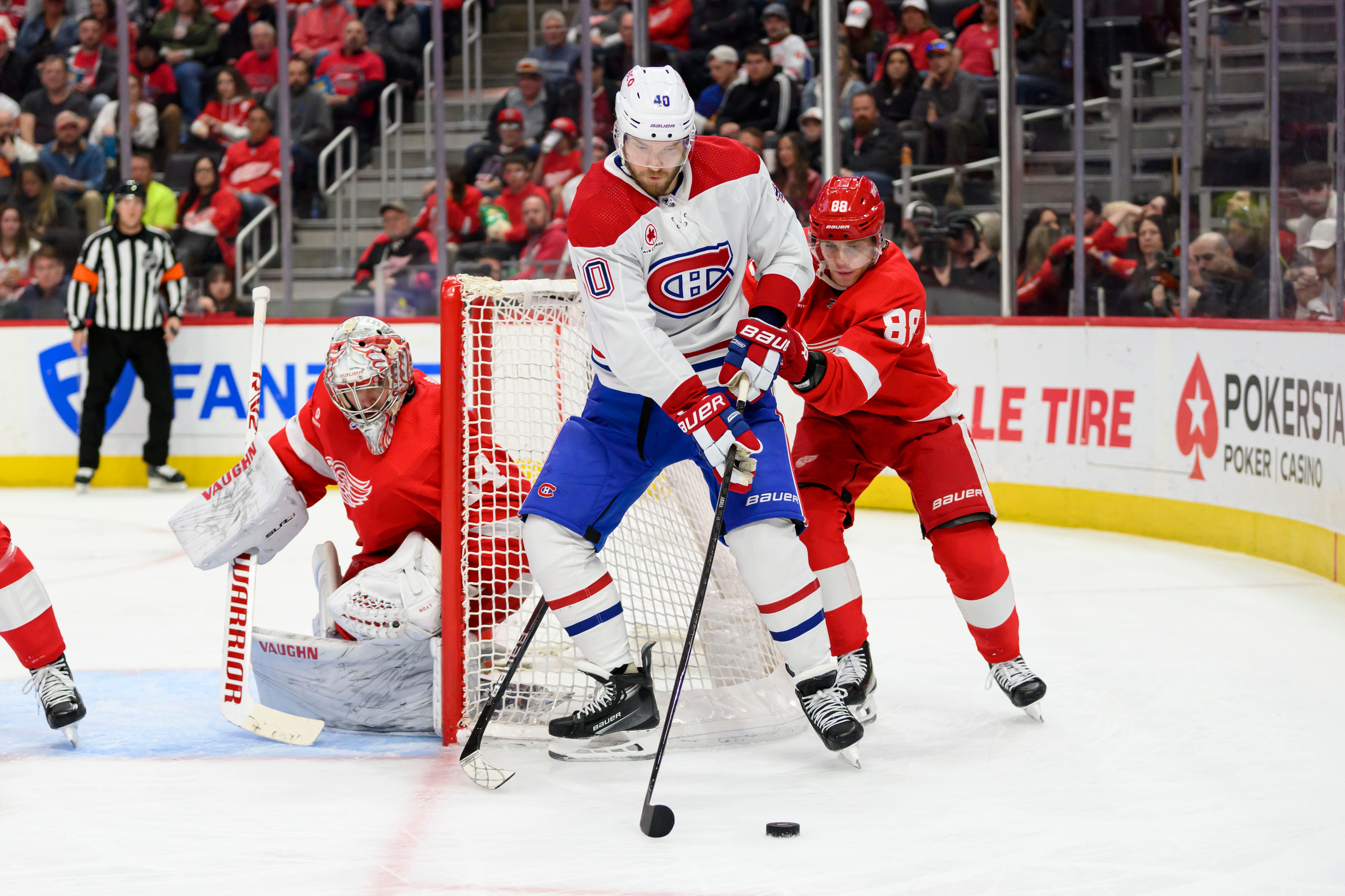 Montreal right wing Joel Armia tries to get the puck past Detroit goaltender Alex Lyon and right wing Patrick Kane during the second period.