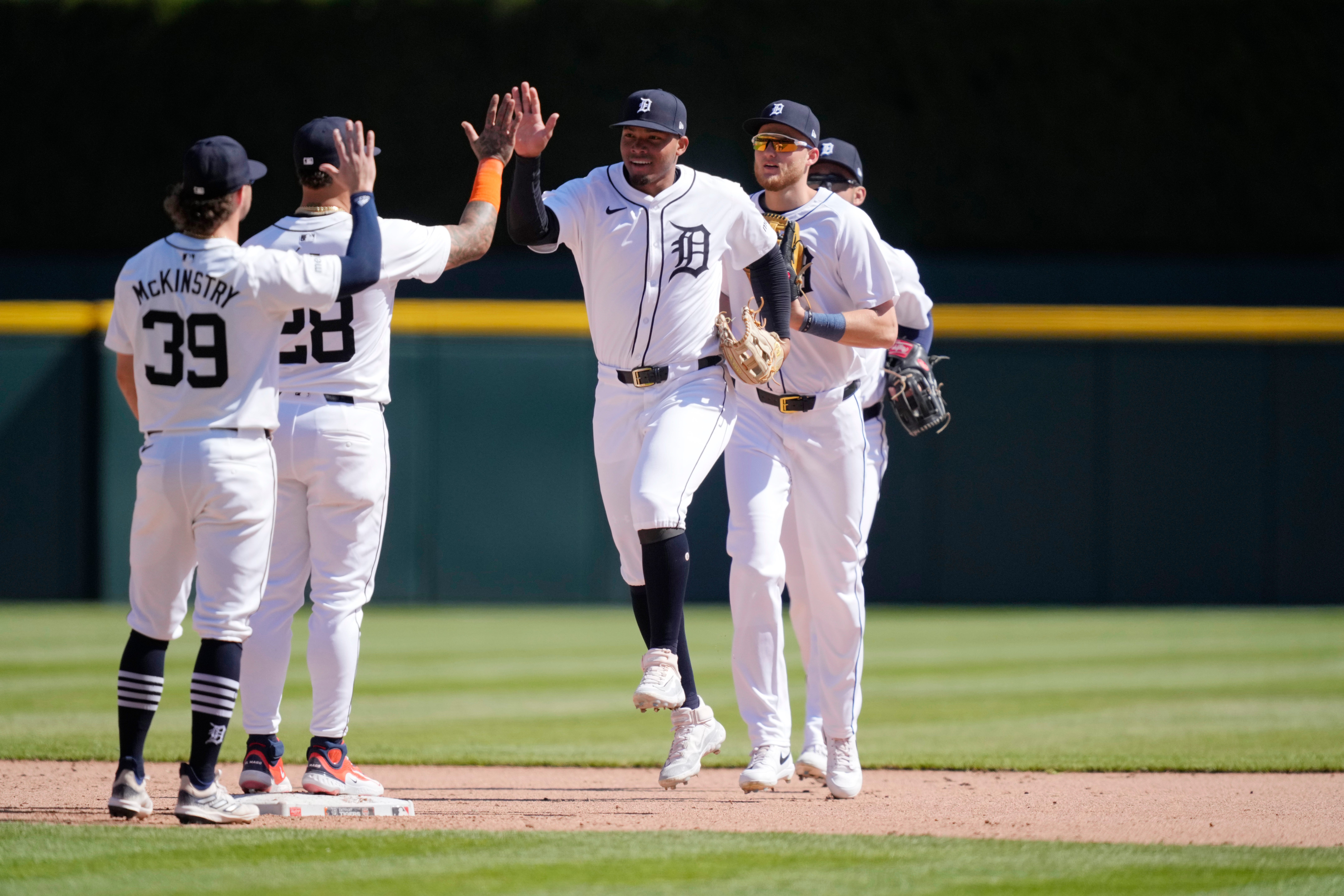 Detroit Tigers right fielder Wenceel Perez high fives shortstop Javier Baez after the end of the ninth inning as the Tigers beat the Rangers, 4 to 2.