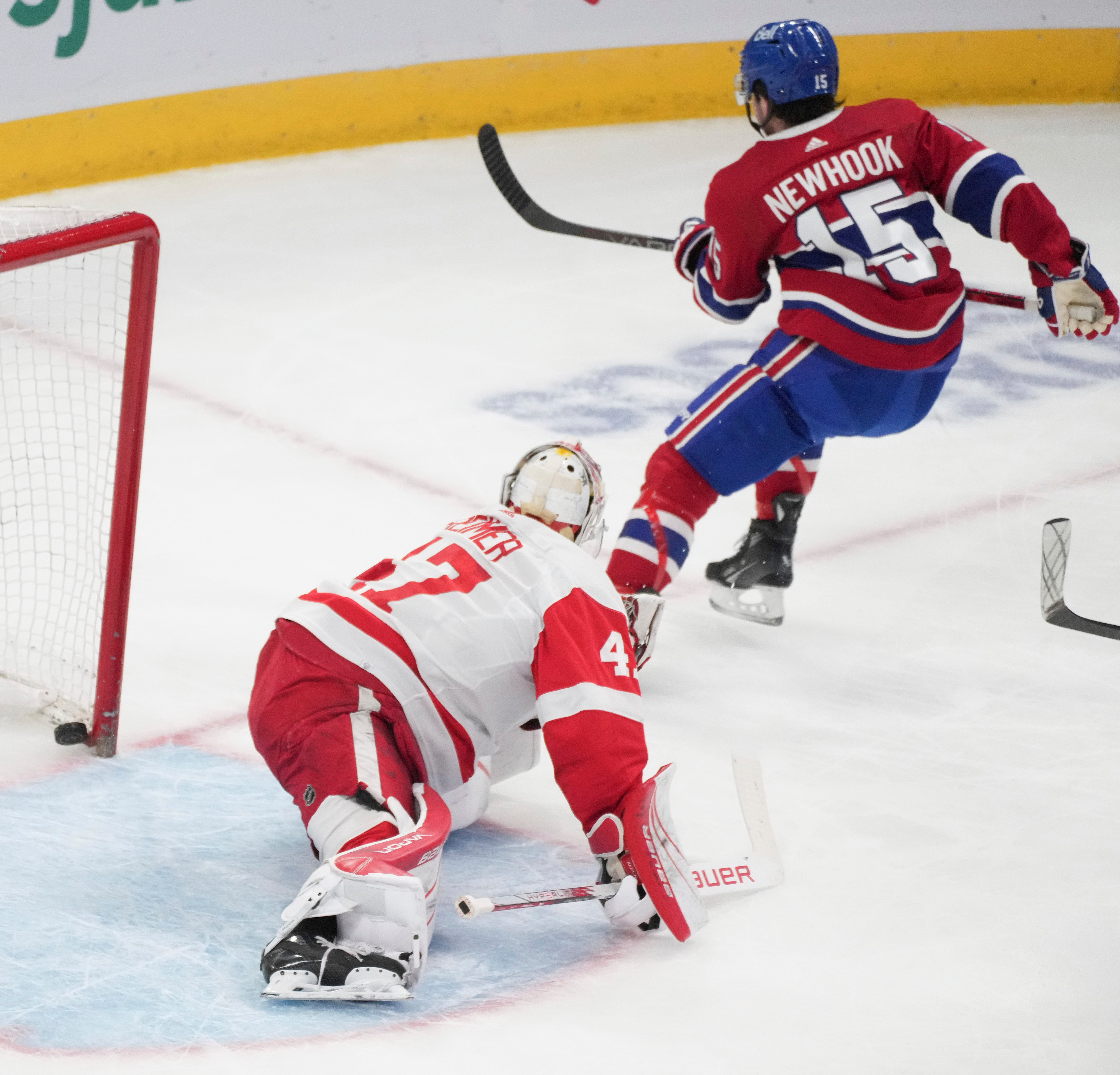 Montreal Canadiens' Alex Newhook (15) scores on Detroit Red Wings goaltender James Reimer (47) during the first period.