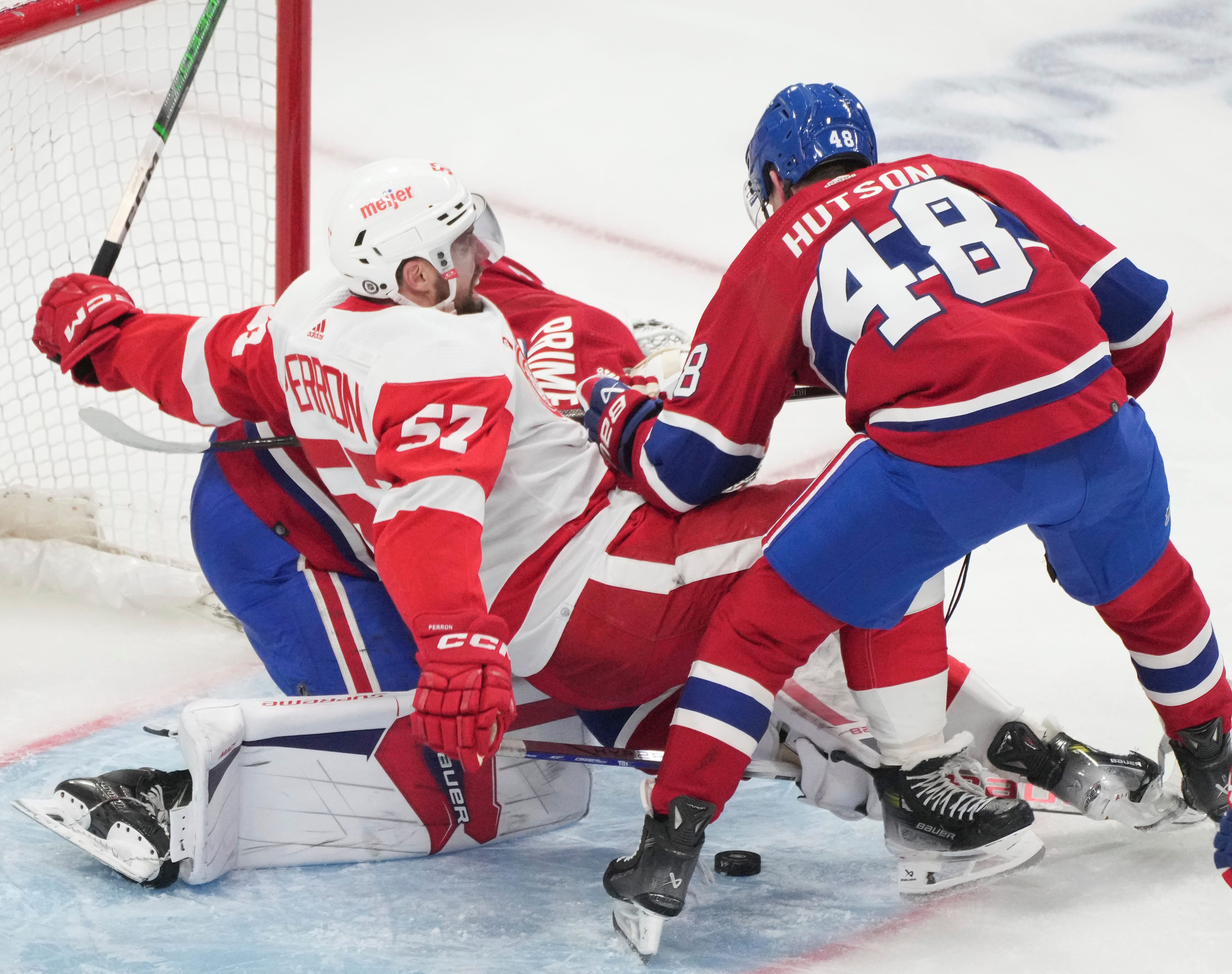 Montreal Canadiens' Lane Hutson (48) battles Detroit Red Wings' David Perron (57) in front of the net during the second period.