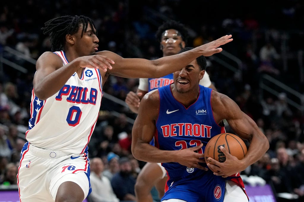 76ers guard Tyrese Maxey (0) defends Pistons guard Jaden Ivey (23) during the first half at Little Caesars Arena in Detroit.
