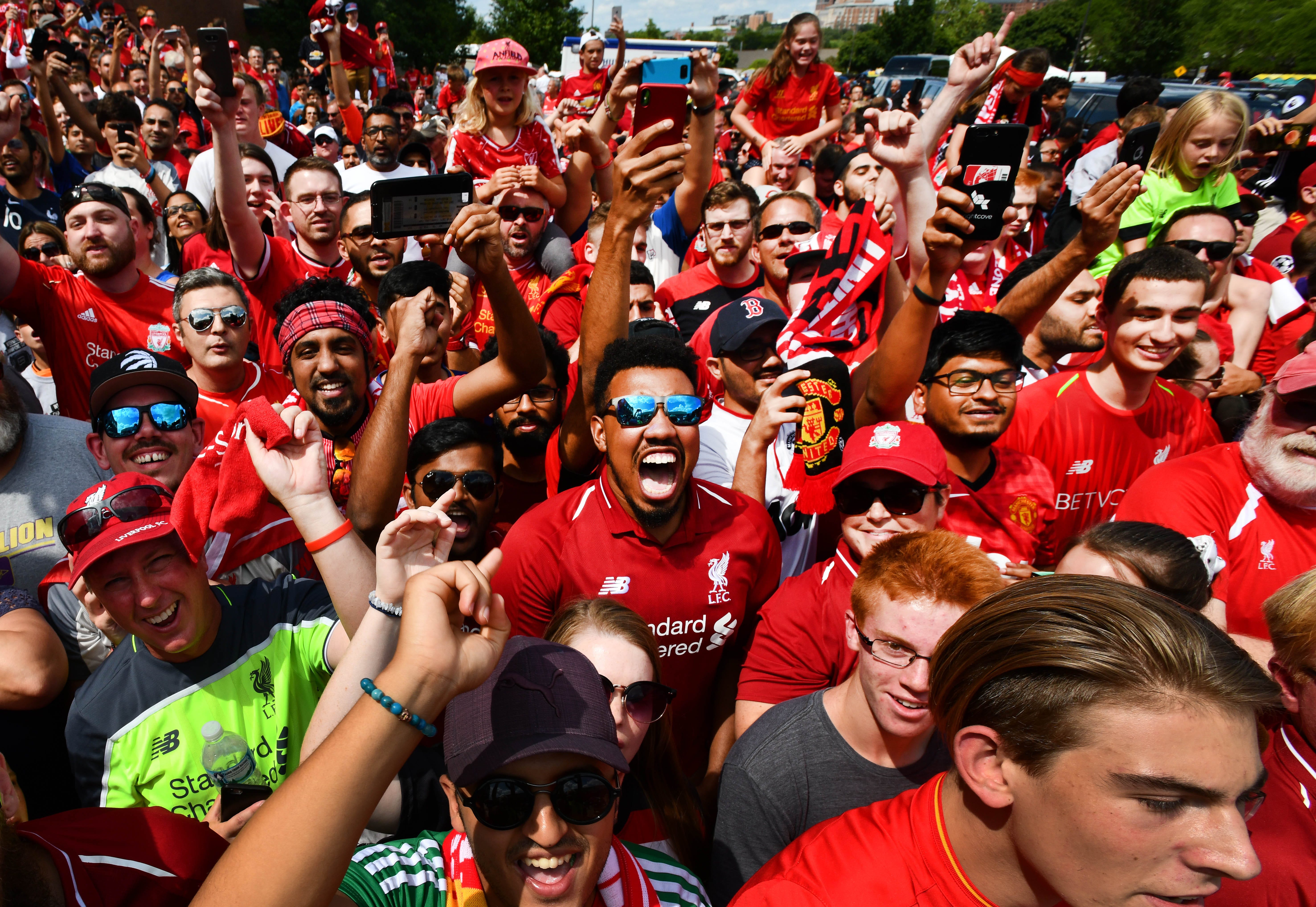 The crowd reacts as Manchester United and Liverpool buses arrive for the International Champions Cup game at Michigan Stadium.