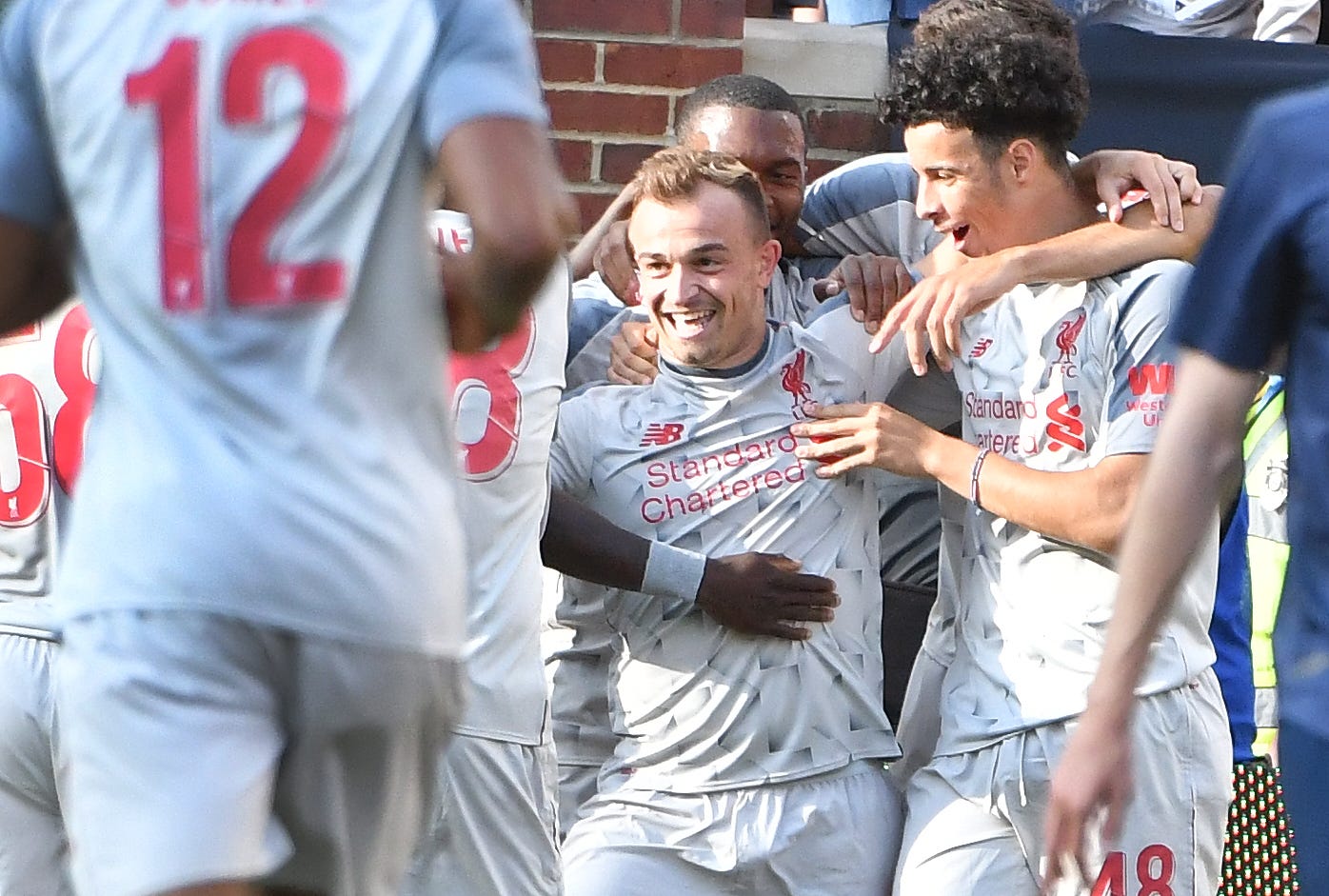 In the second half, Midfielder Sheridan Shaqiri celebrates after putting in goal #4 for Liverpool in the 4-1 victory over Manchester at Michigan Stadium.