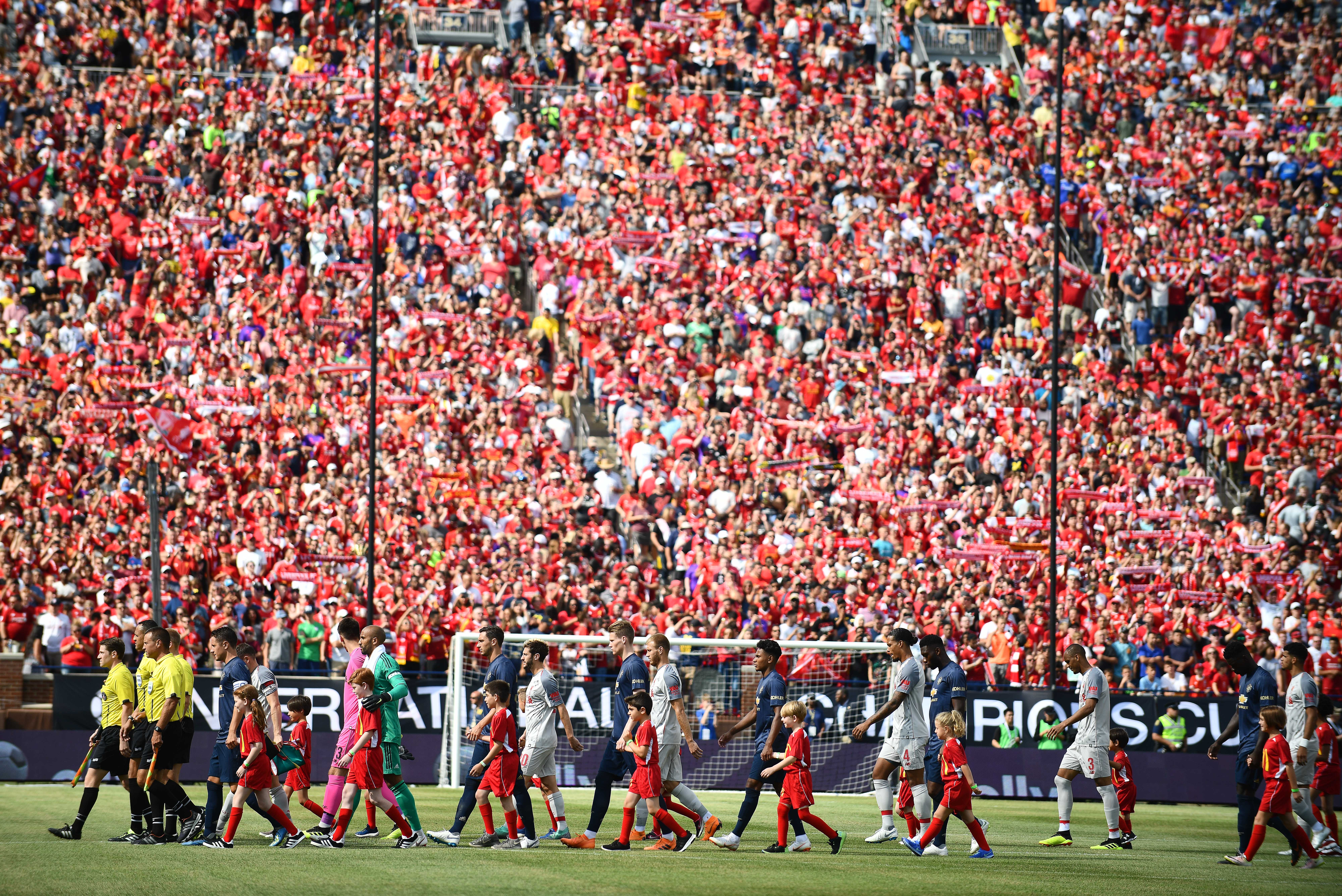 Manchester United and Liverpool make their way onto the field as over 100,000 fans cheer them on at The Big House.