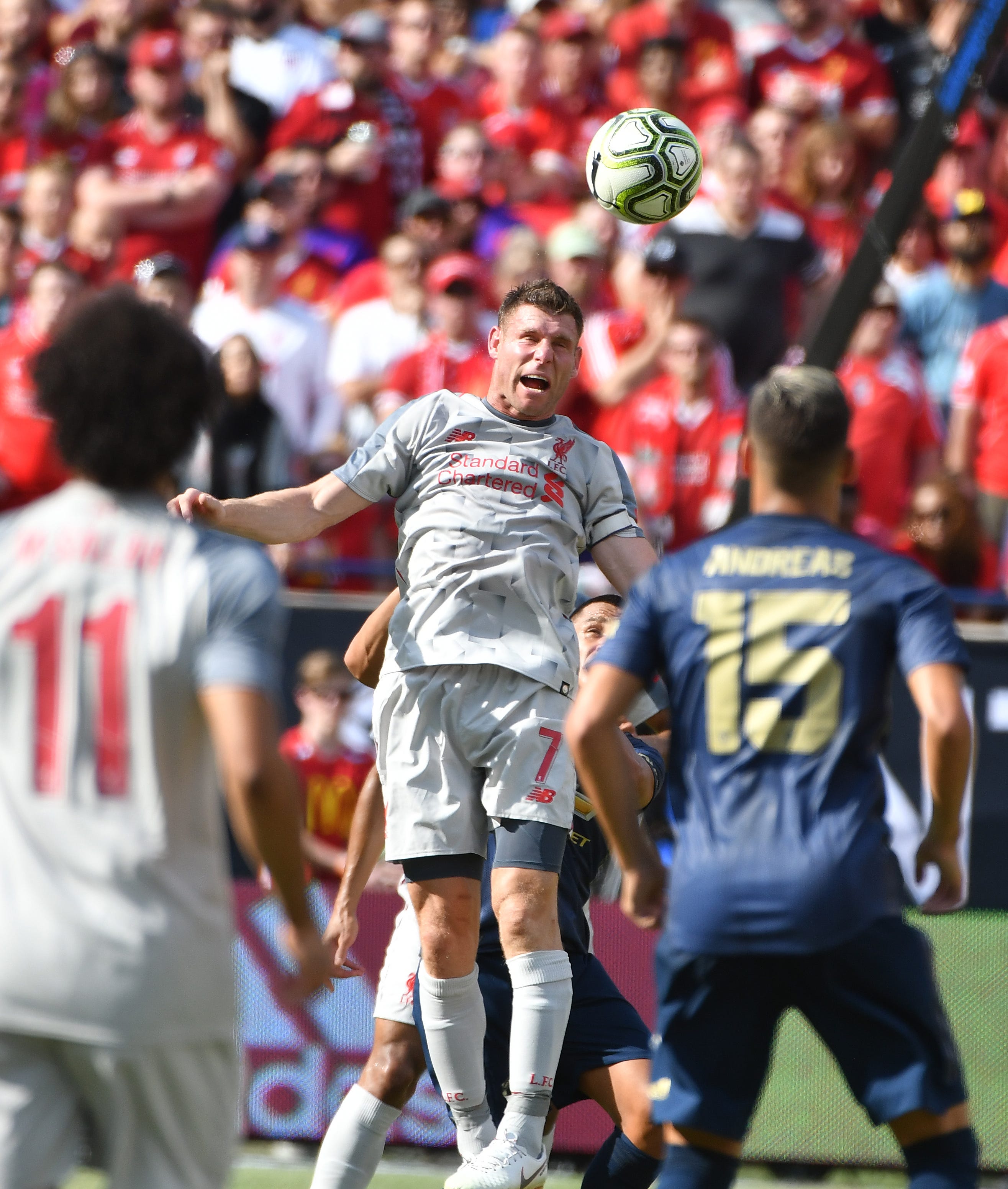 Liverpool's James Milner heads a ball back up field in the first half.