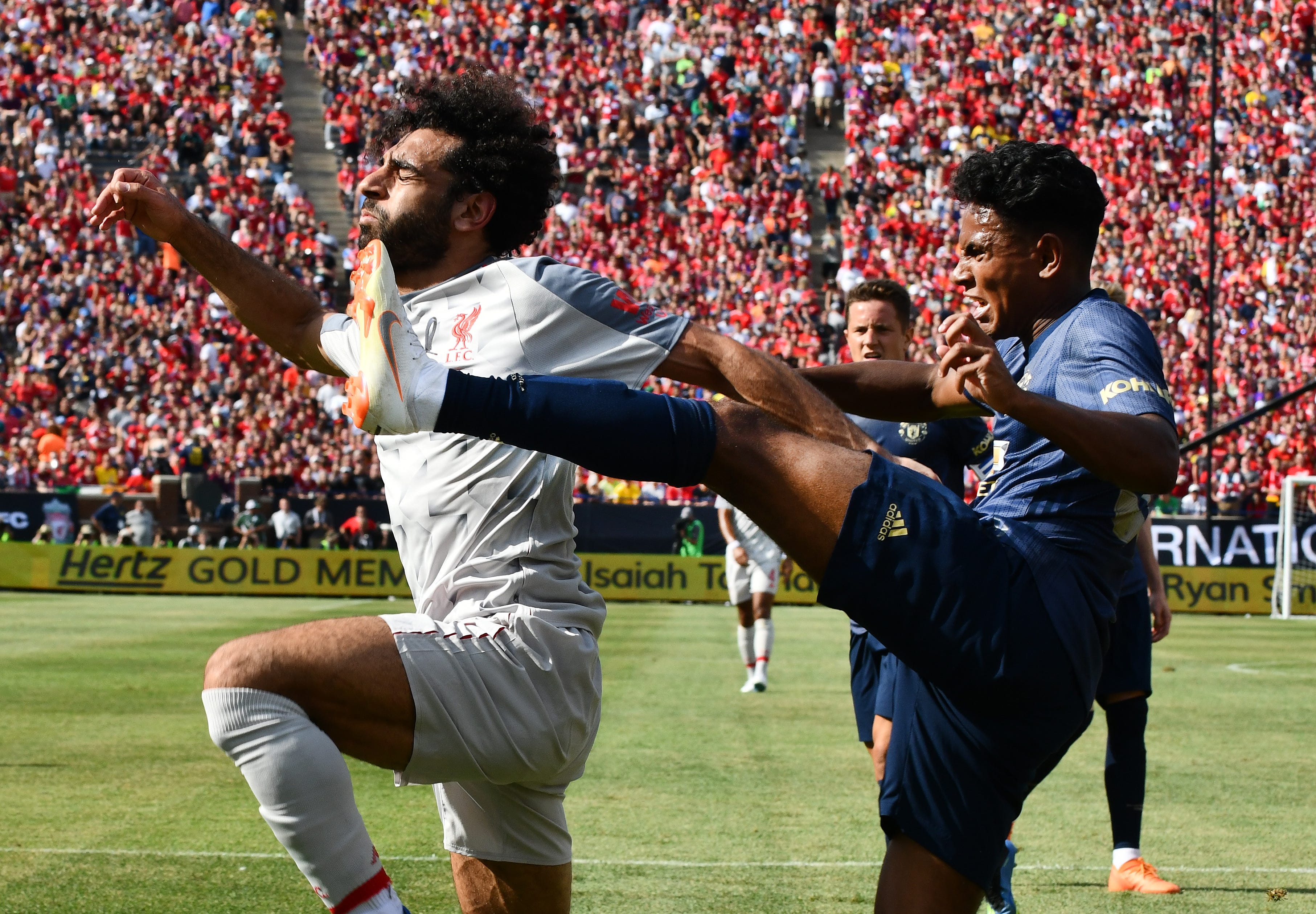 Liverpool's Mohamed Salah gets kicked in the face by Manchester United's Demetri Mitchell, which gave Liverpool a penalty kick and put it on the board first in the first half of the International Champions Cup at Michigan Stadium on the campus of University of Michigan in Ann Arbor, Michigan on July 28, 2018. Liverpool won the match, 4-1.