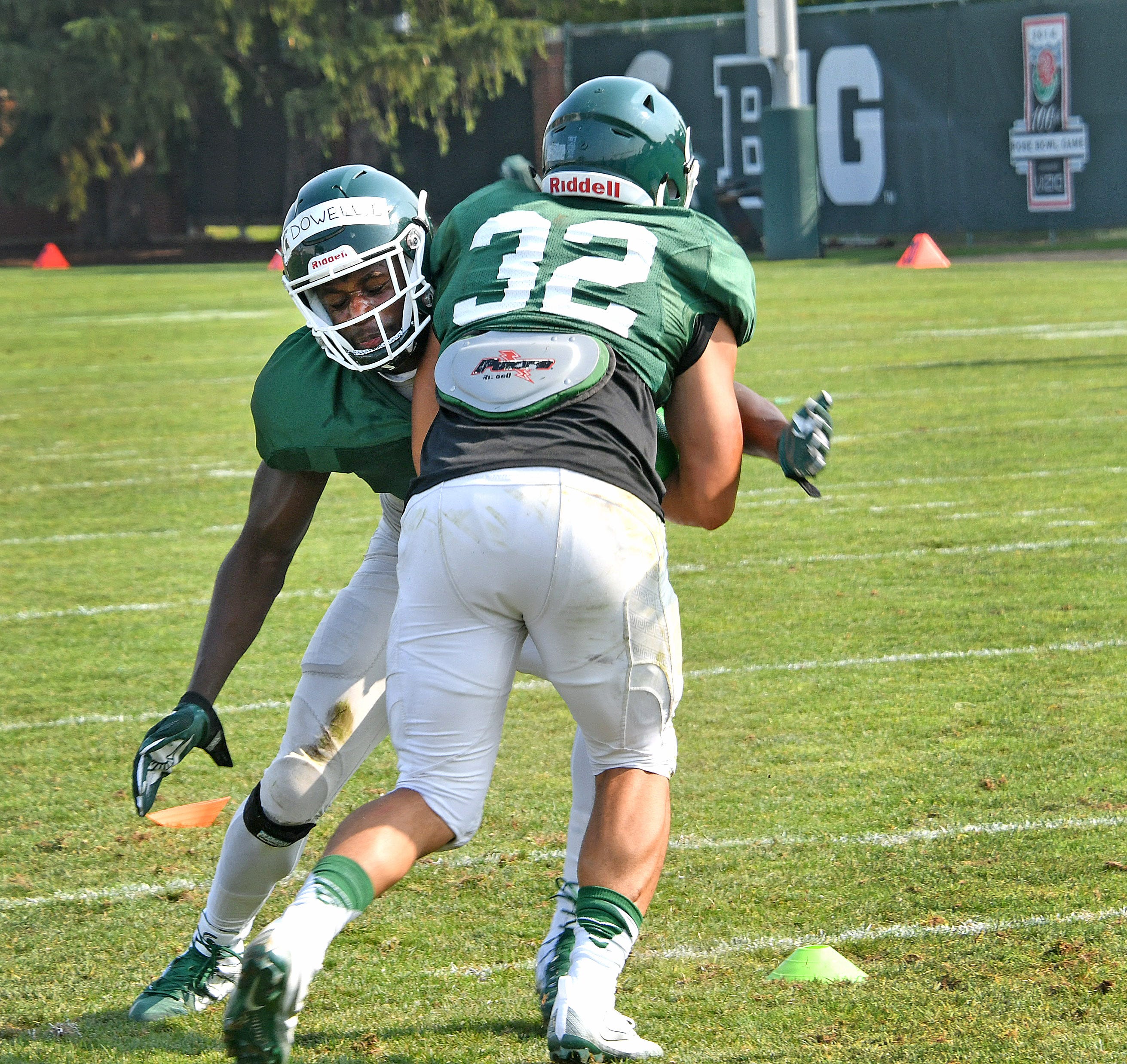 Michigan State linebacker Andrew Dowell puts a tackle on teammate Corey Pryor during a drill early in the practice.