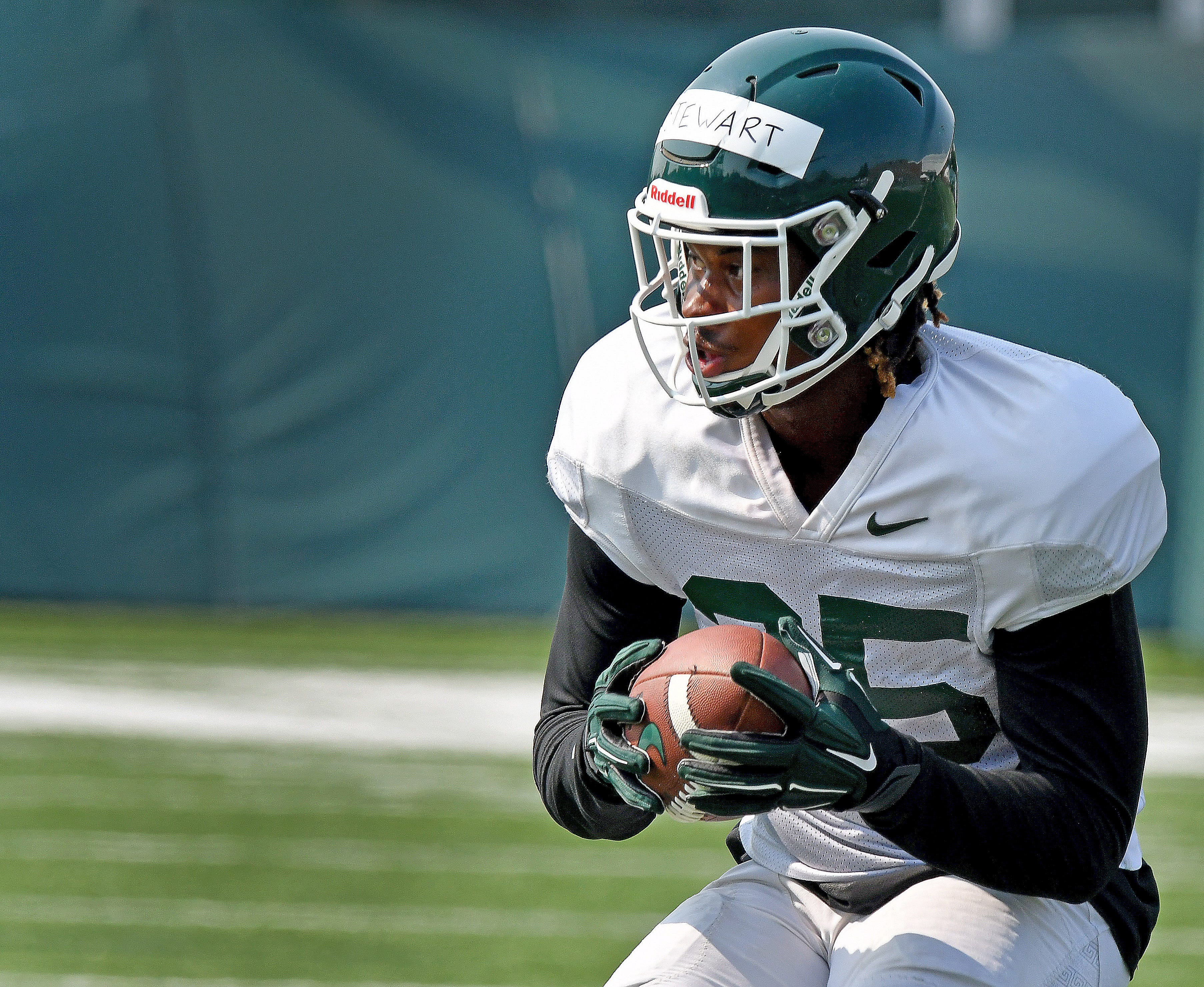 Michigan State receiver Darrell Stewart catches the ball and turns toward the goal line.
