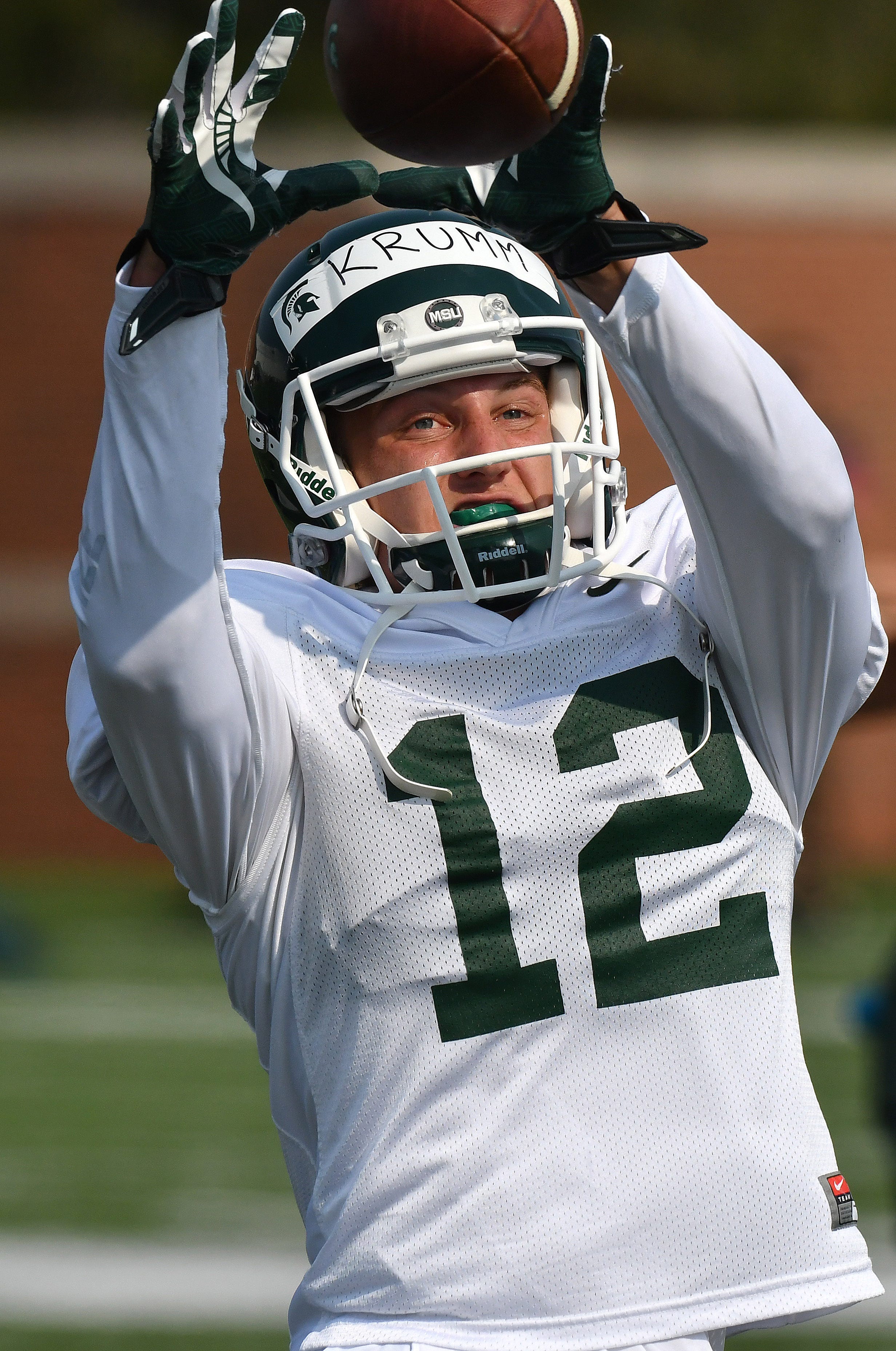 Michigan State receiver Nick Krumm pulls in the football while running pass routes.