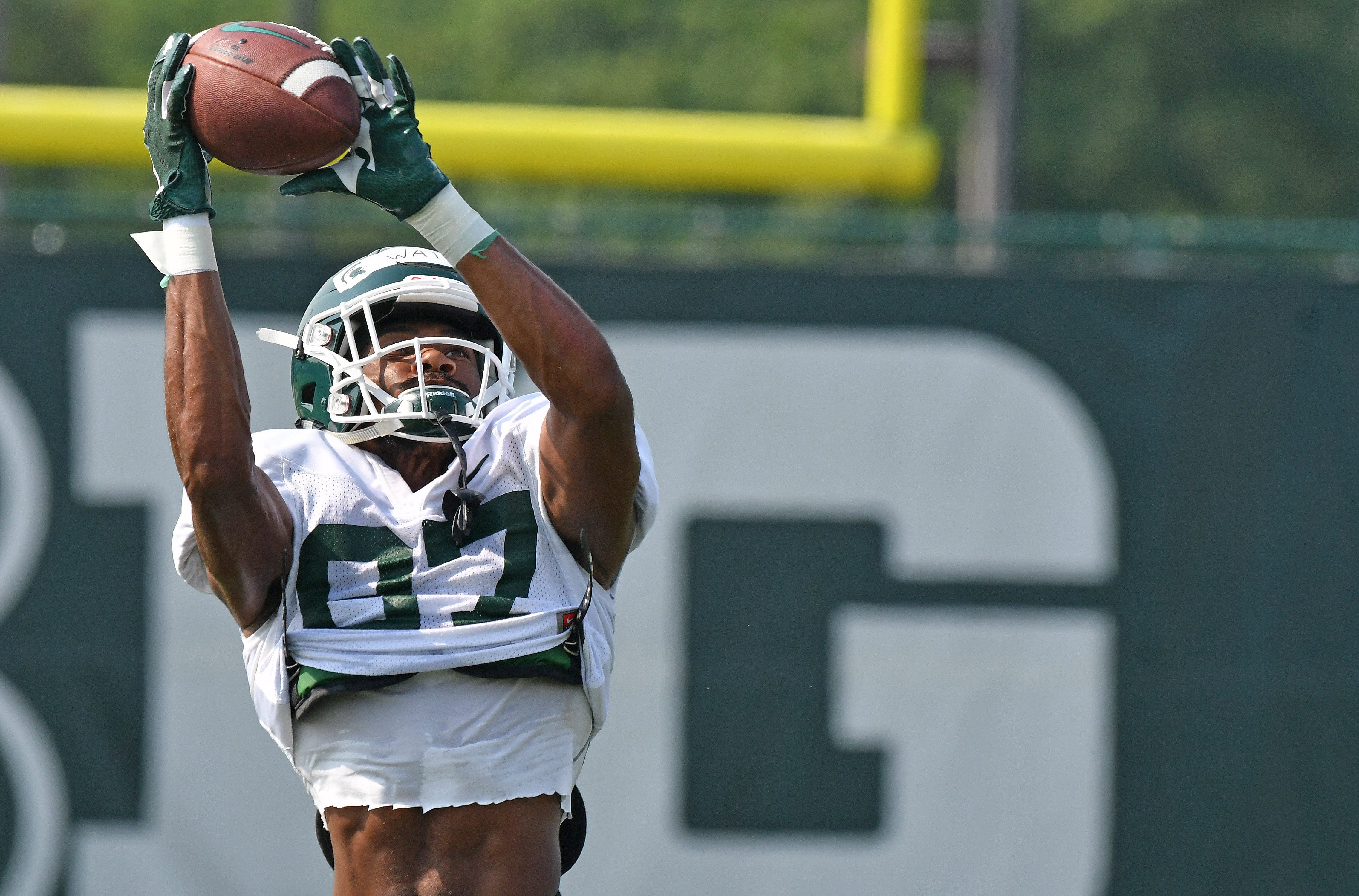 Michigan State receiver Jahz Watts pulls down a pass over his head.