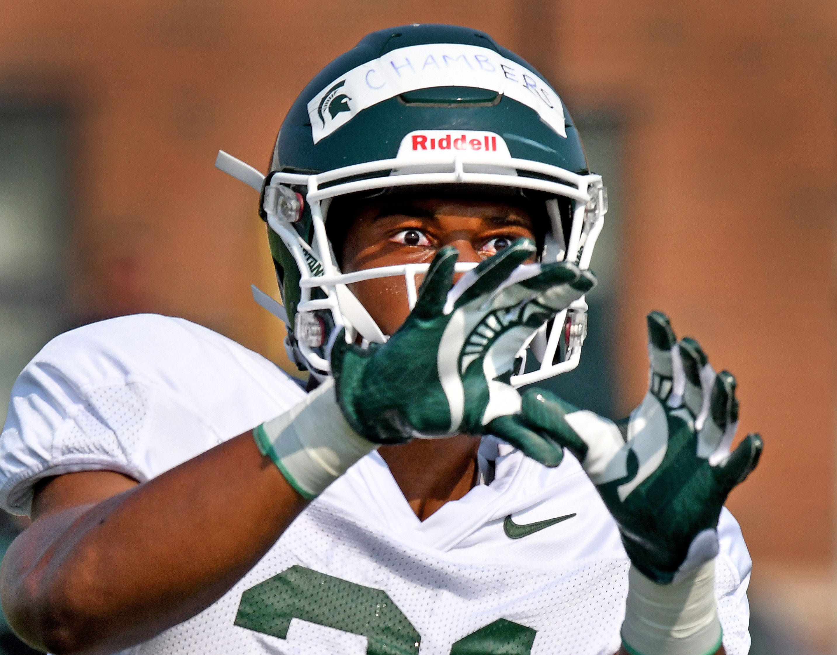 Michigan State receiver Cam Chambers has his eyes on the ball during pass-route drill.