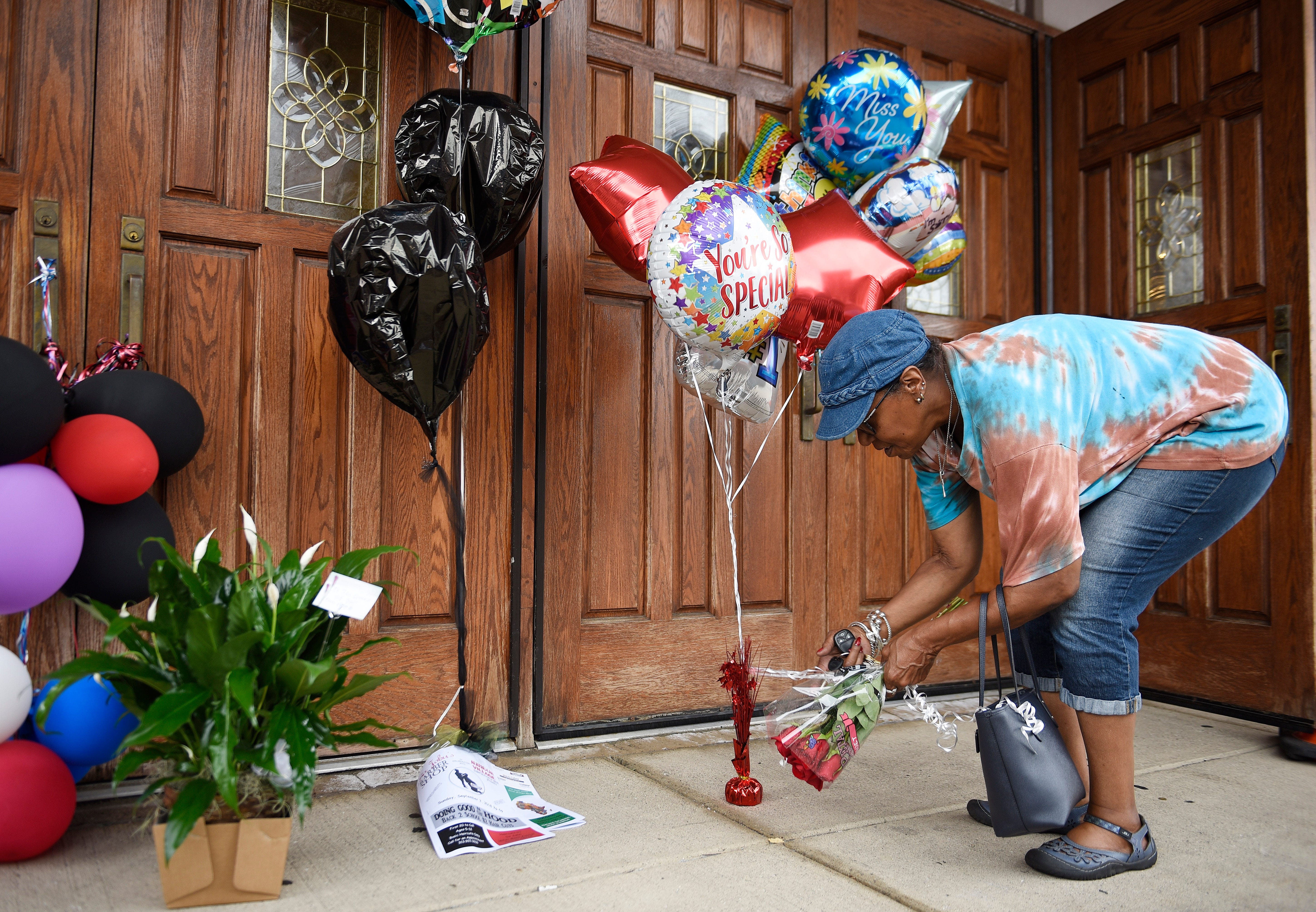 Cecily McClellan, 66, of Detroit leaves flowers at an impromptu Aretha Franklin memorial site at New Bethel Baptist Church, in Detroit.