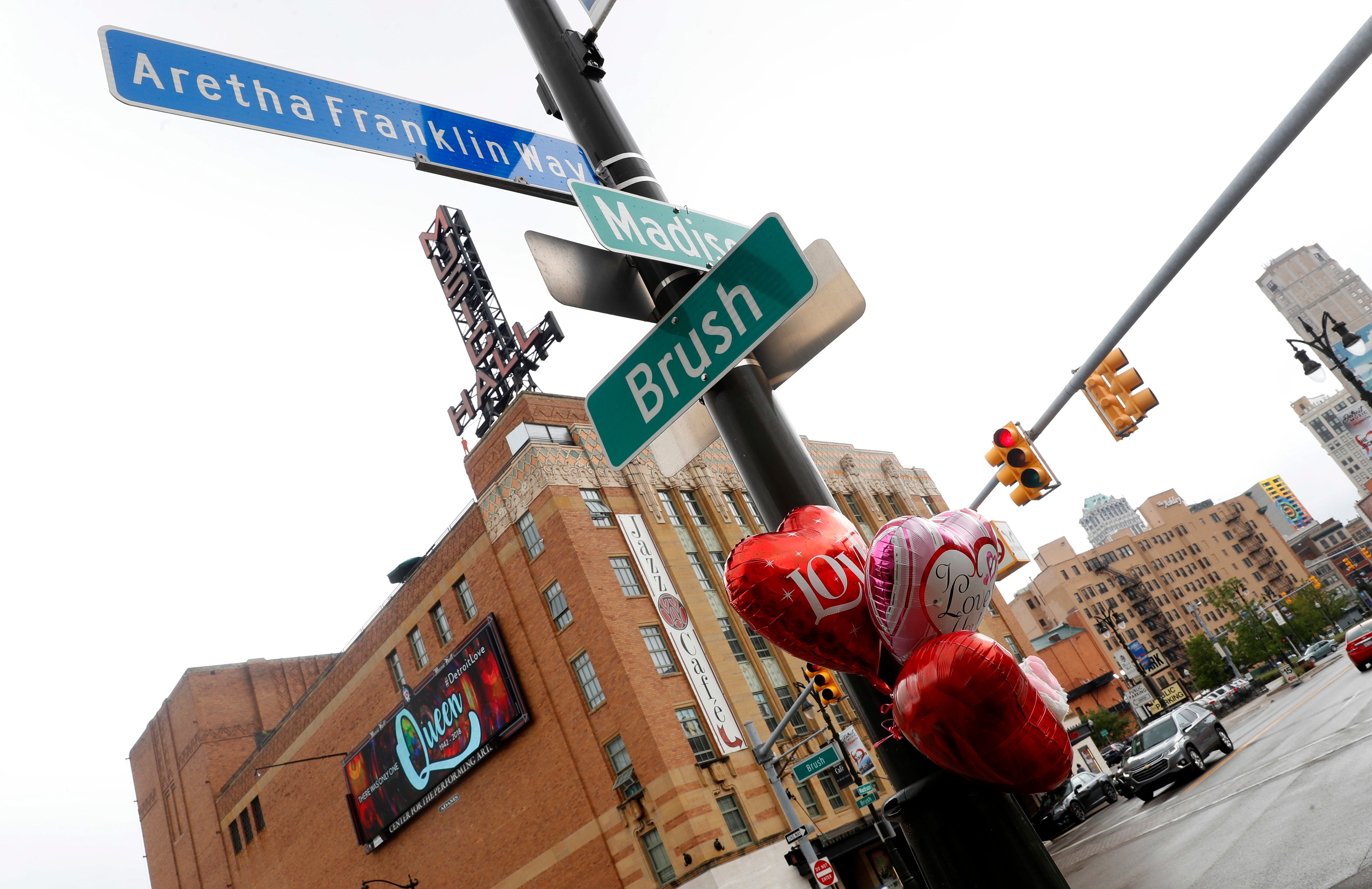 Balloons hang in Aretha Franklin's honor on a street post at Aretha Franklin Way in Detroit, Thursday.