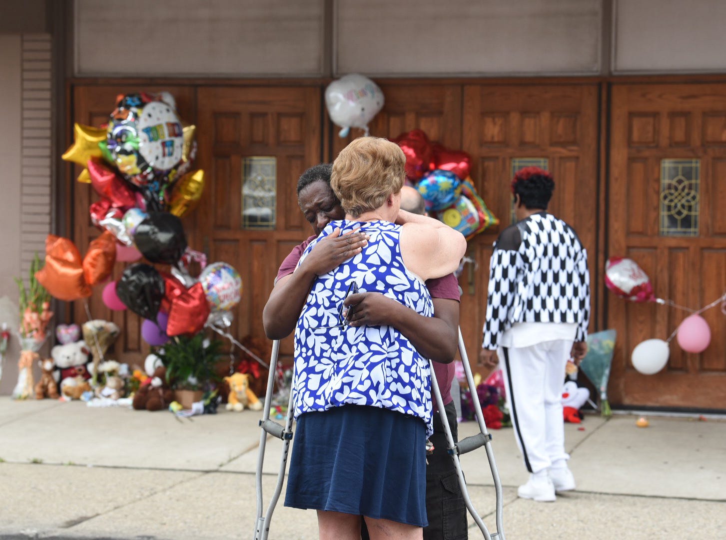 Terence Blair of Detroit hugs Melody Hause of Auburn Hills as they grieve outside the New Bethel Baptist Church in Detroit, where memorials to Aretha Franklin were collecting on Friday, August 17, 2018.