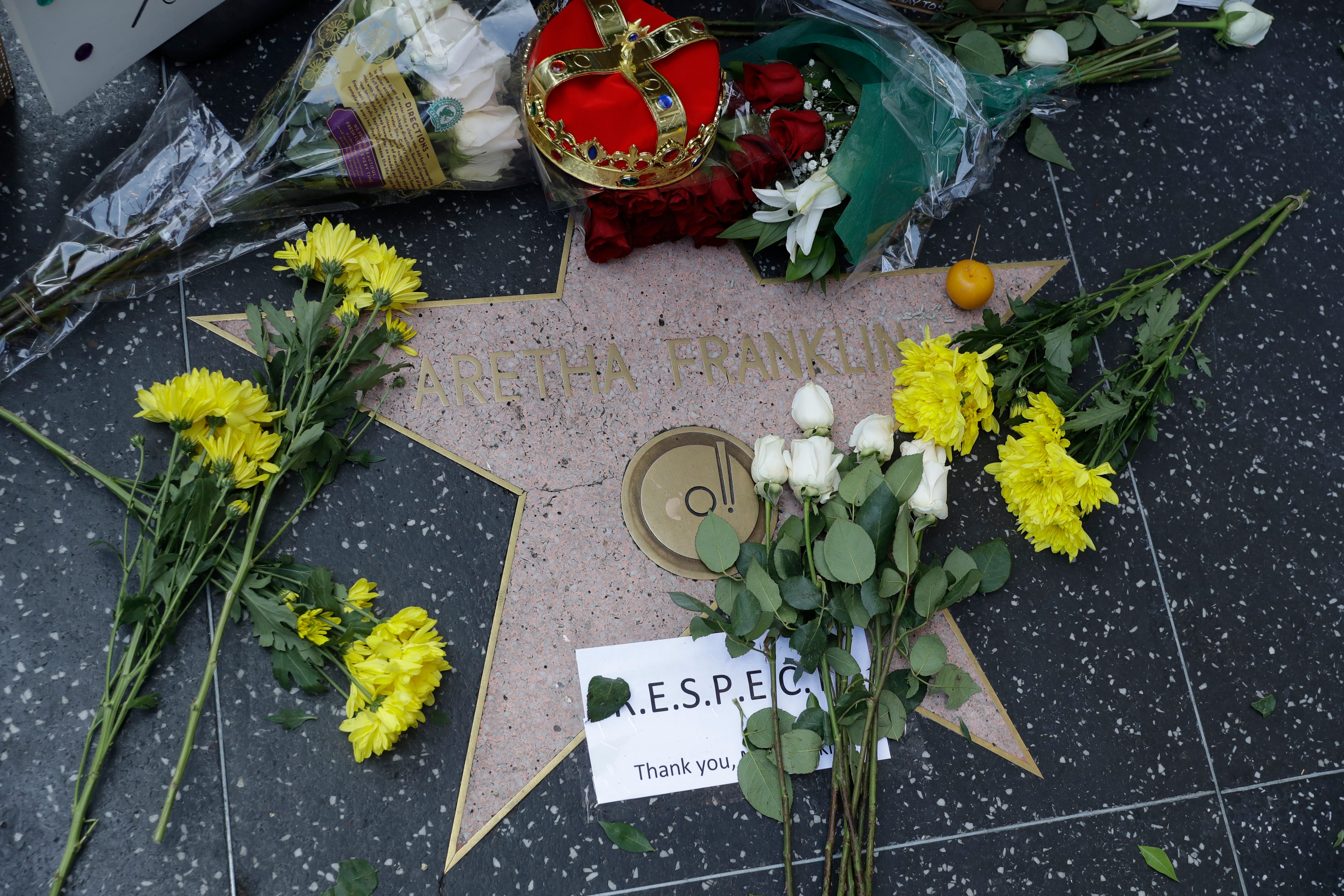 Flowers and signs are placed on Aretha Franklin's star at the Hollywood Walk of Fame Thursday in Los Angeles.