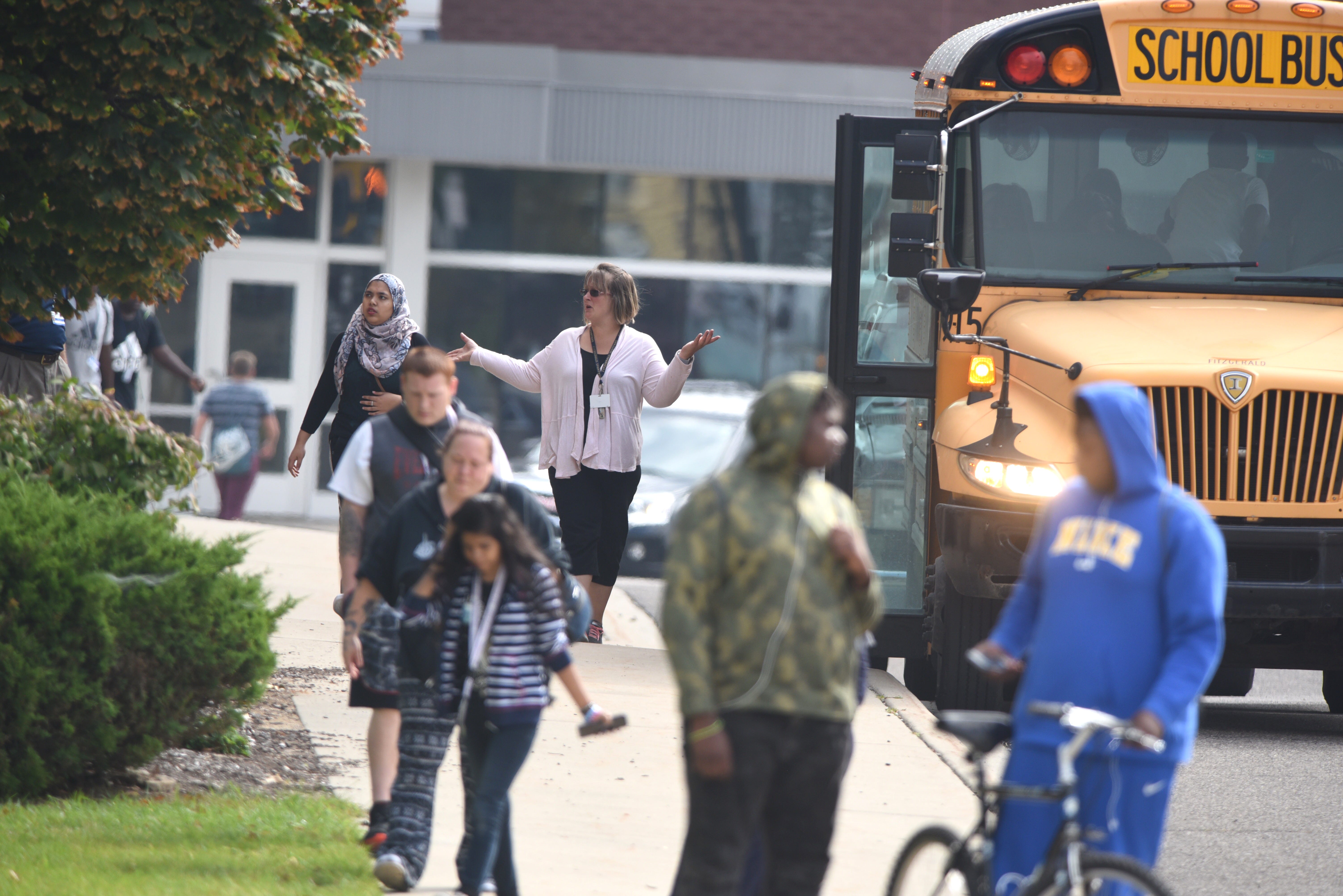 A Warren Fitzgerald High School teacher directs students off campus after the stabbing.