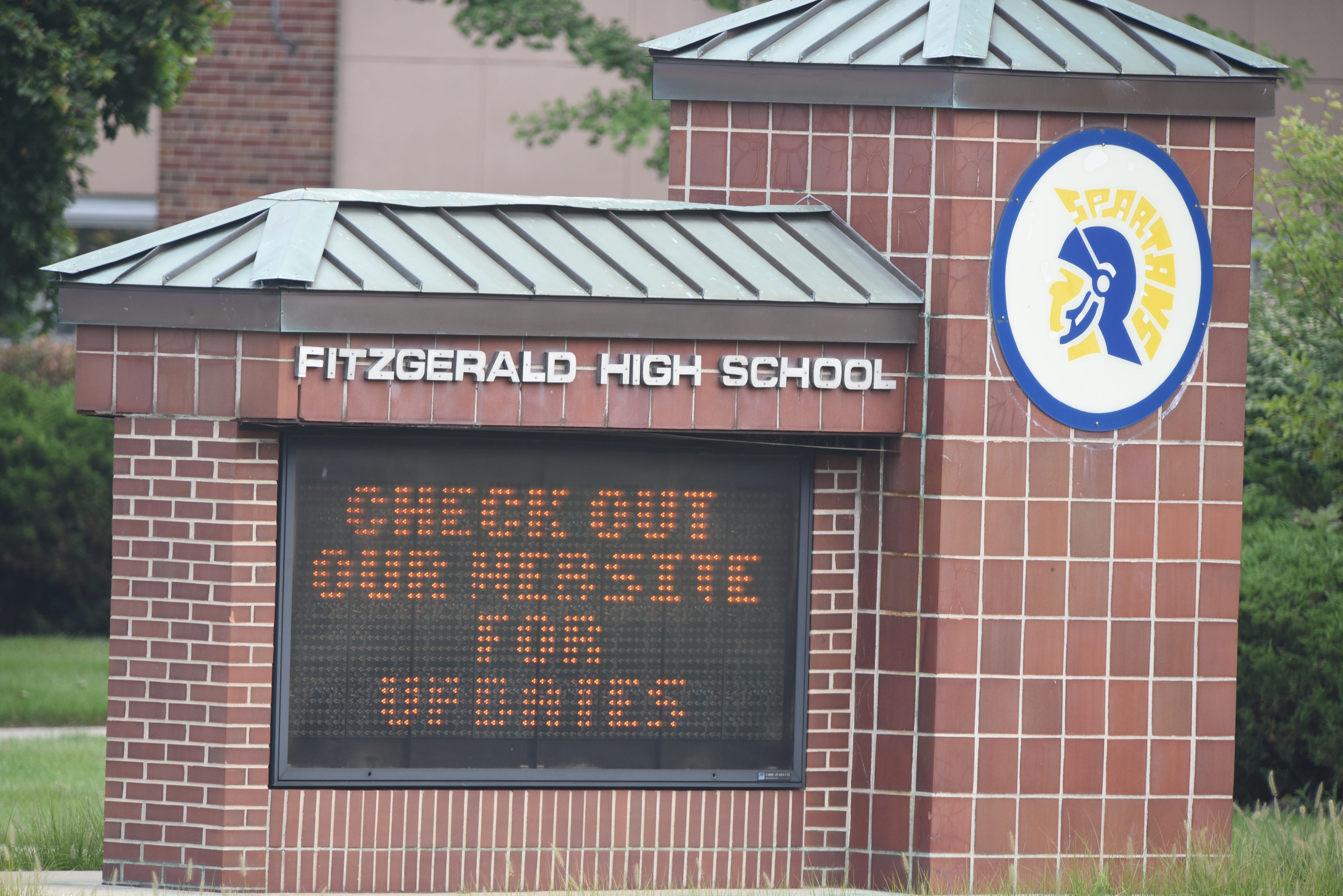 The entry sign at Warren Fitzgerald High School refers passersby to its website for updates.