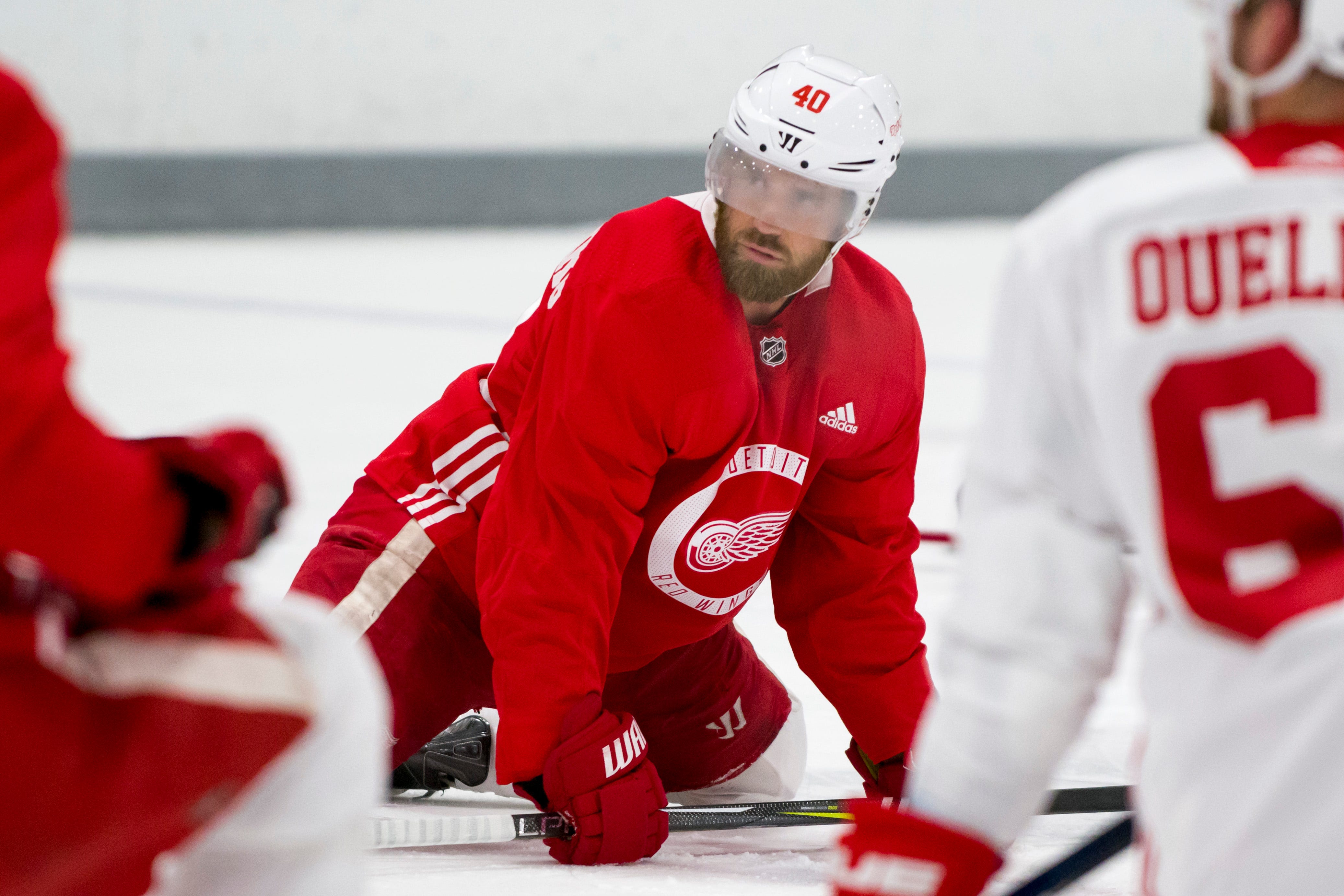 The facemark of center Henrik Zetterberg fogs up as he stretches before the workout in Traverse City on Sept. 15, 2017