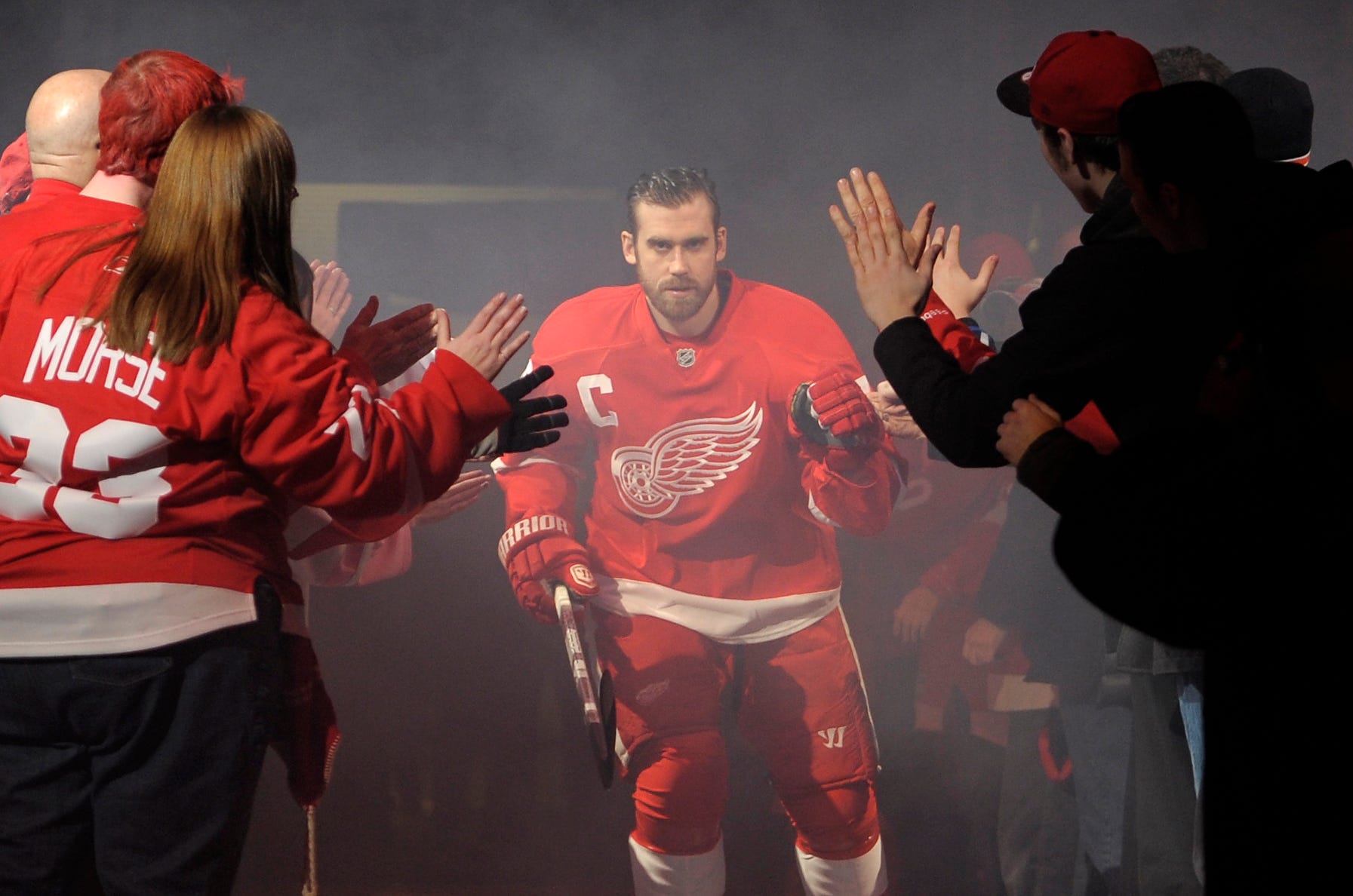 Henrik Zetterberg skates out onto the ice to the welcome of fans during the pre-game ceremony before the start of a game against the Dallas Stars at Joe Louis Arena in Detroit, January 22, 2013.