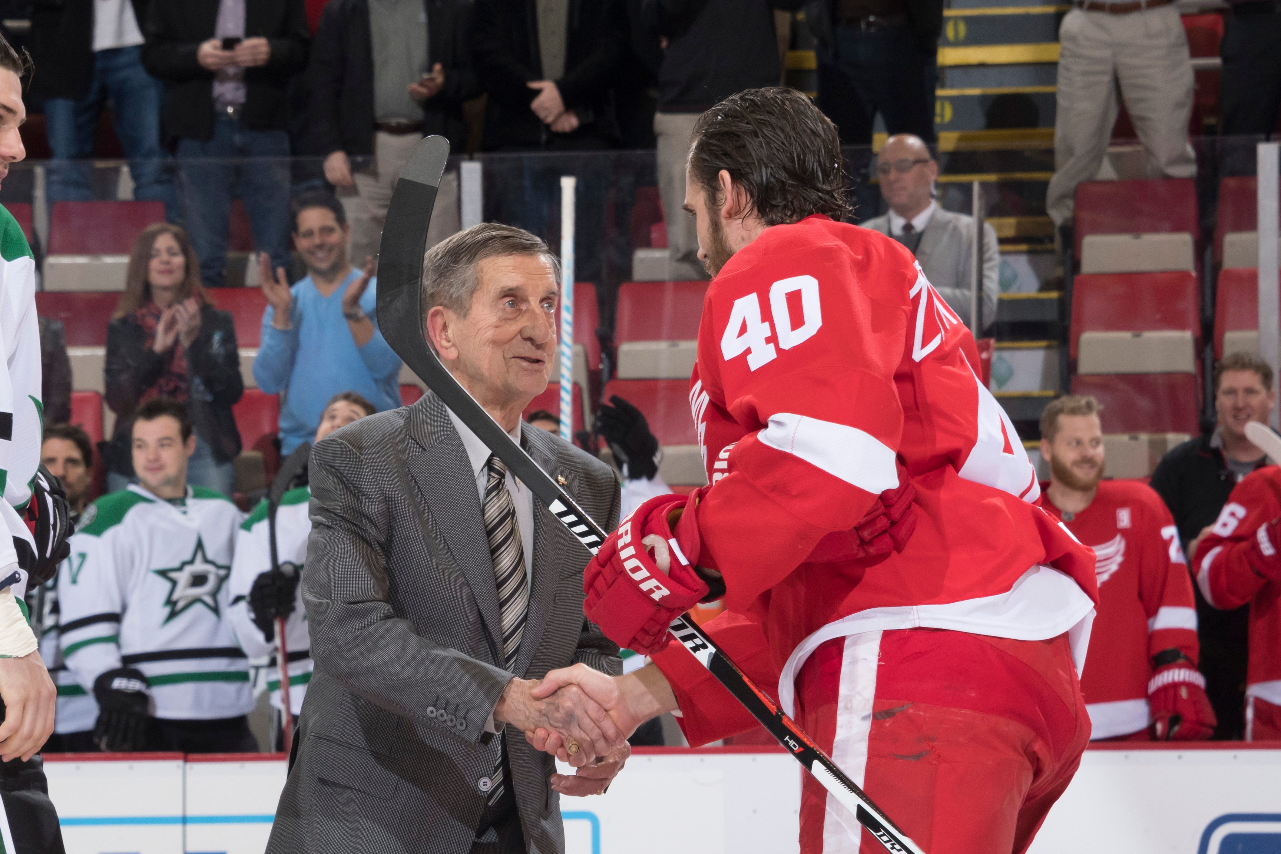 Red Wing Hall of Famer Ted Lindsay shakes hands with Henrik Zetterberg after performing a ceremonial puck drop.