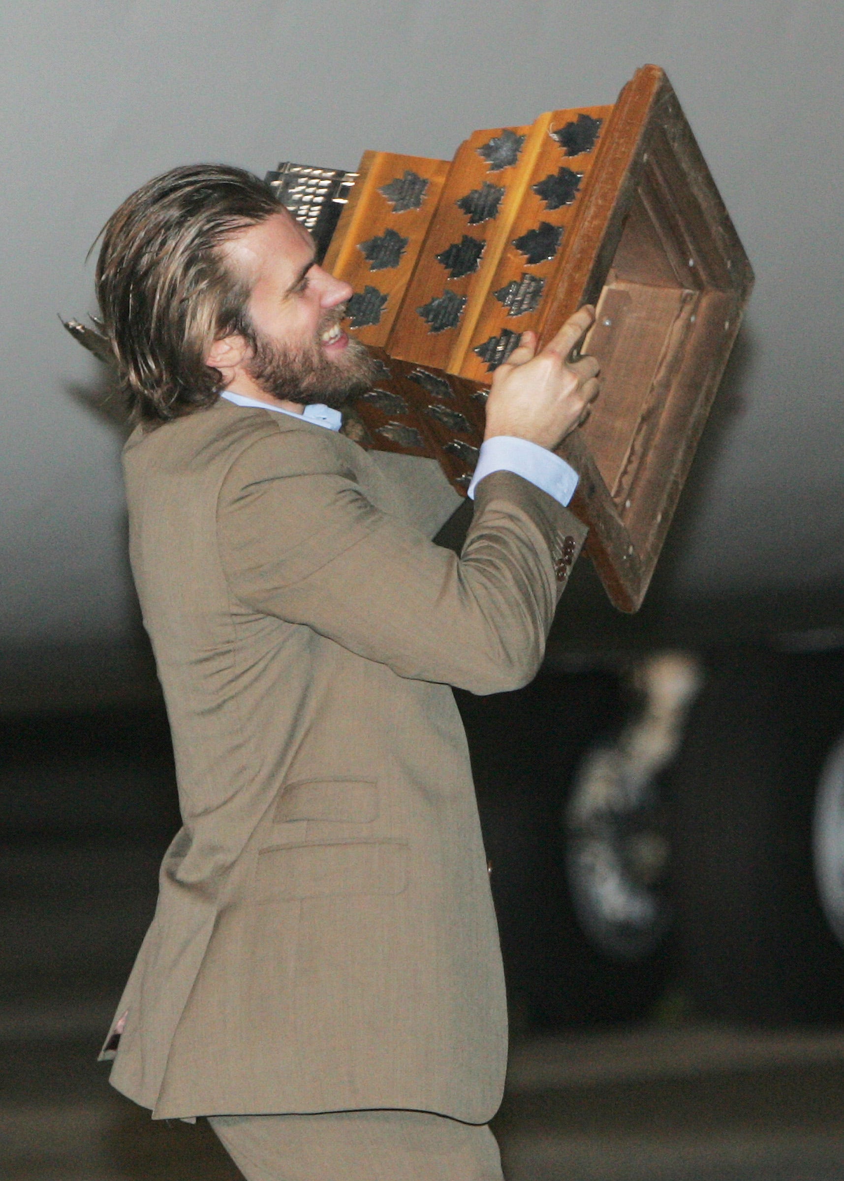 Red Wings' Henrik Zetterberg carries his Conn Smythe Trophy
off of the plane. The Detroit Red Wings, Stanley Cup champions, are welcomed home with a party at ASIG General Aviation Services at Metro Airport in Romulus on June 4, 2008 after winning the Cup in Pittsburgh.