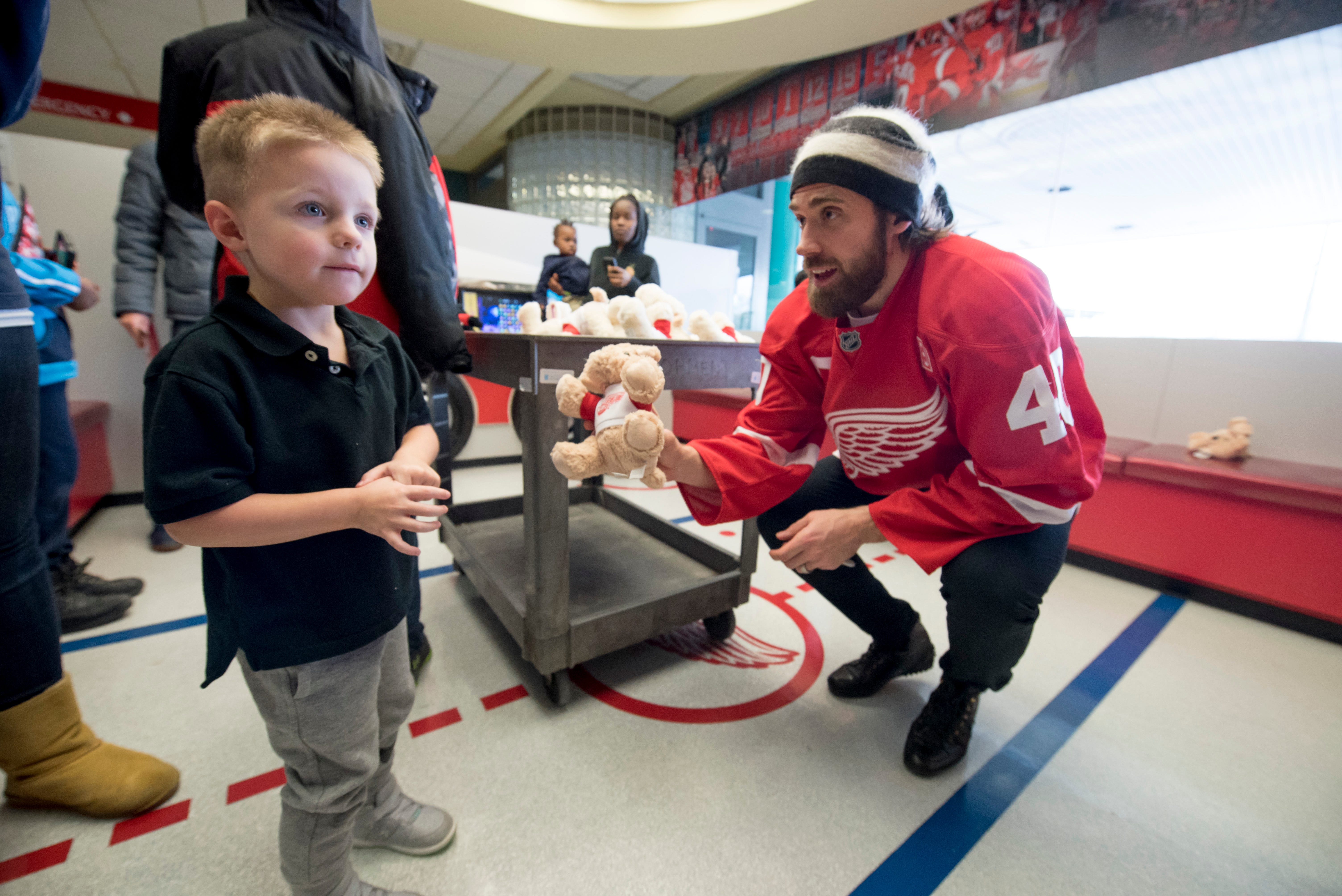 Jaxon Drake, of Chesterfield, finds himself a little shy as Red Wings captain Henrik Zetterberg tries to give him a stuffed bear while visiting patients at Children ' s Hospital of Michigan.