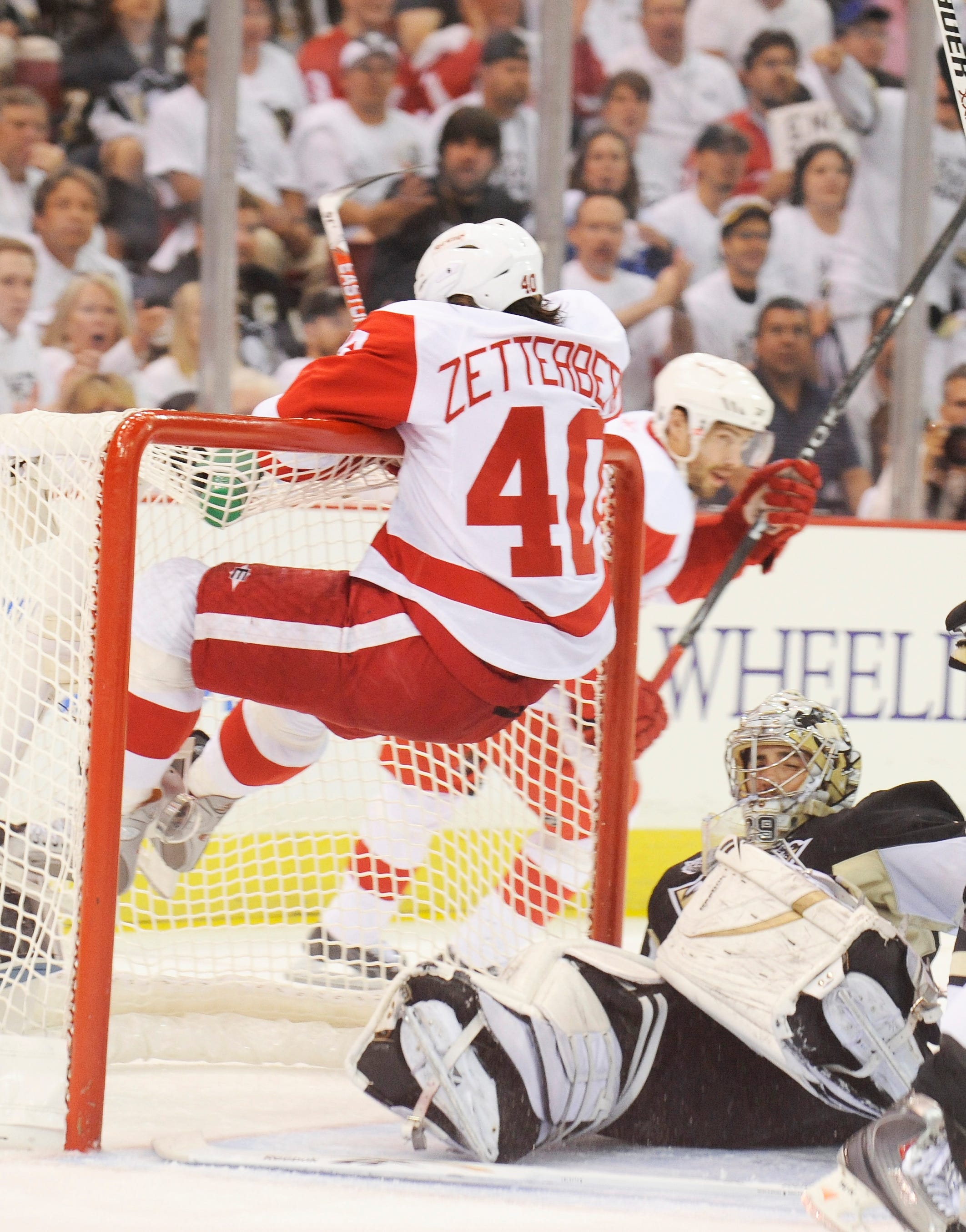 Red Wings center Henrik Zetterberg hangs from the crossbar after running into Pittsburgh Penguins goalie Marc-Andre Fleury. He was whistled for goaltender interference in Game 6 of the Stanley Cup Final in Pittsburgh on June 9, 2009.