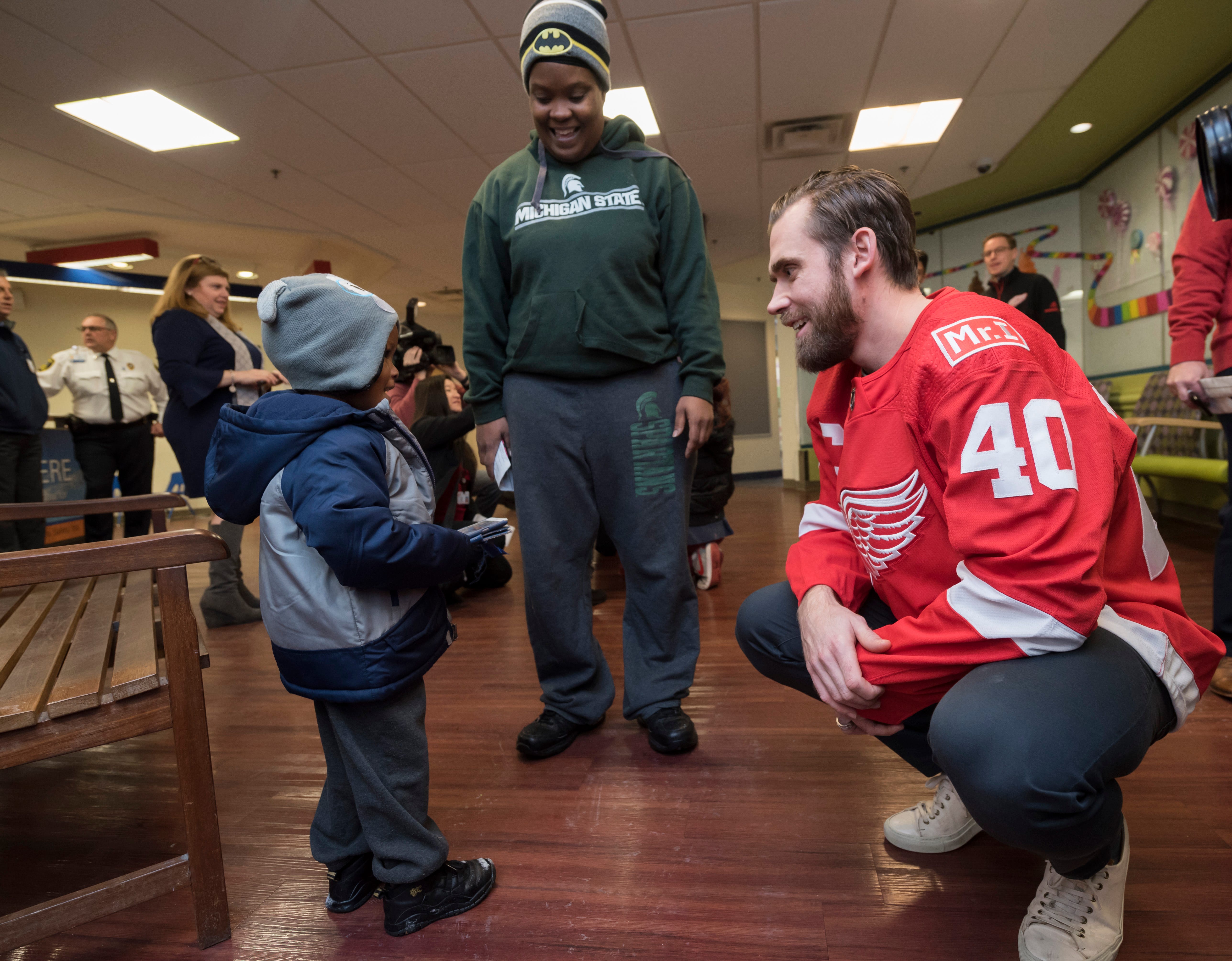 Detroit left wing Henrik Zetterberg chats with Noah Simms, 3, of Detroit, during the Detroit Red Wings annual visit to Children ' s Hospital in Detroit, Dec. 12, 2017.