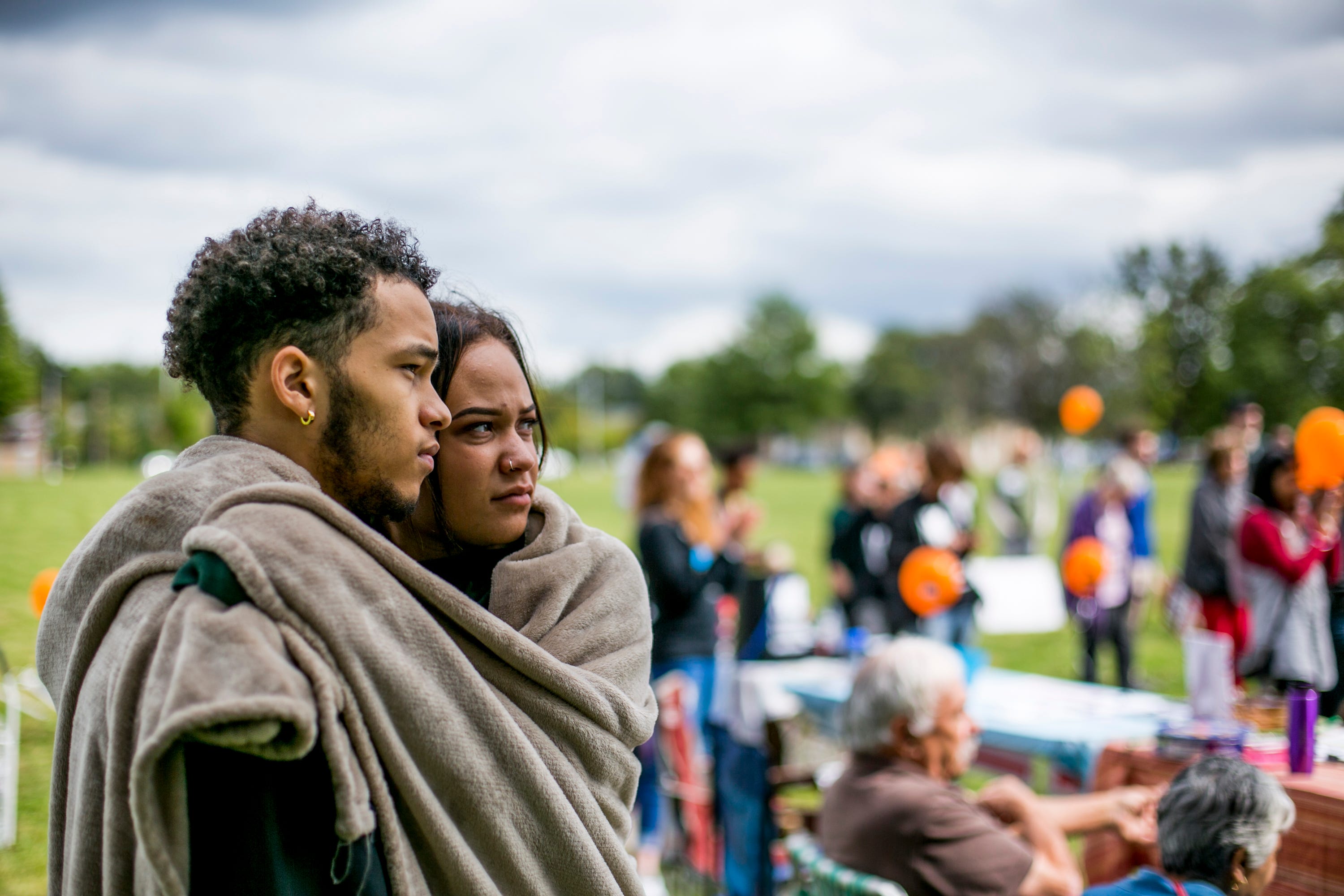 Mibdrea Ray, 18, a sexual assault survivor from Kalamazoo and her boyfriend Mark Anderson, 18, of Kalamazoo, listen to the speakers during the Slut Walk at Palmer Park in Detroit on September 22, 2018.