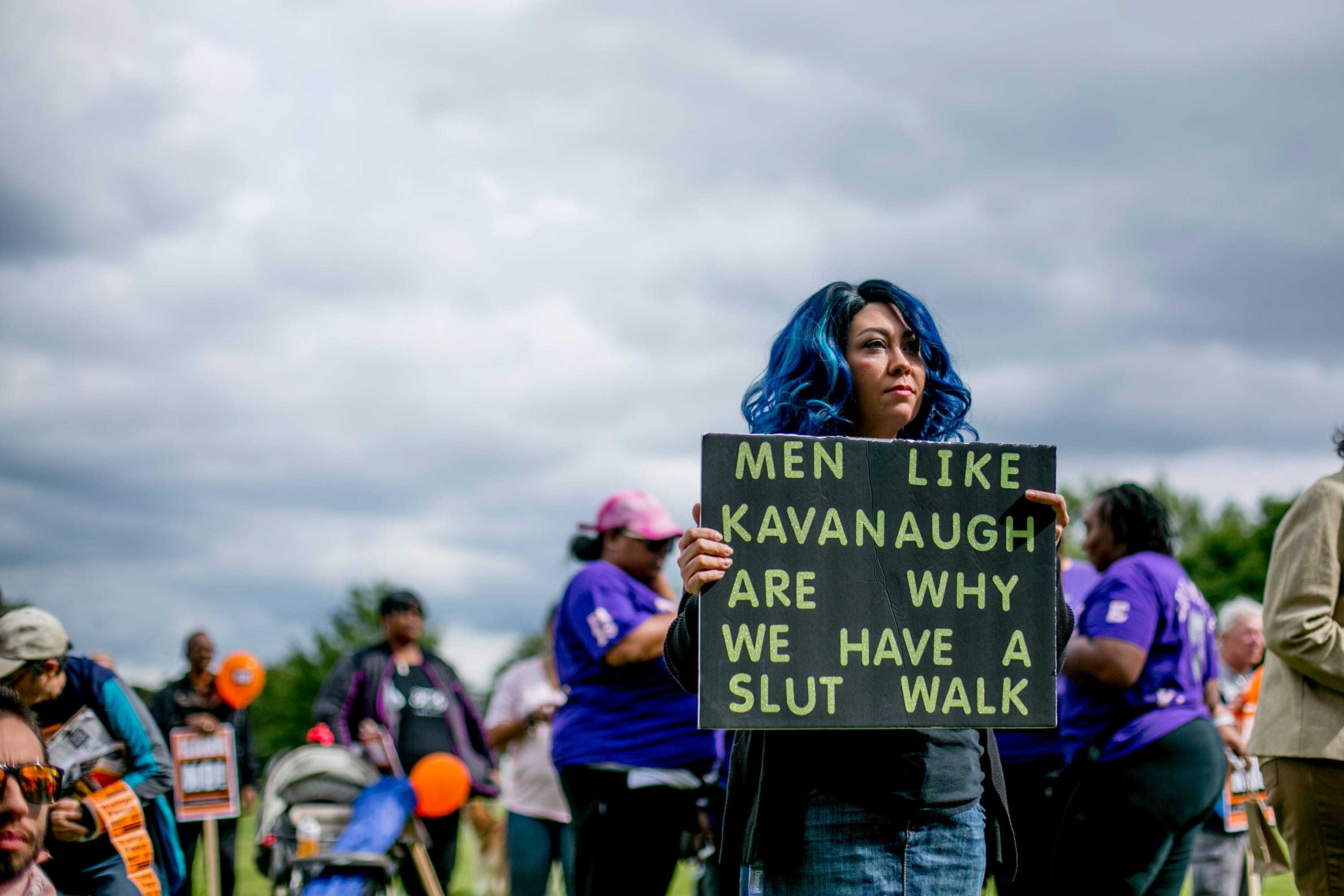 Megan Baxter, 30, of Dayton, Ohio, holds a sign during the Slut Walk at Palmer Park in Detroit.