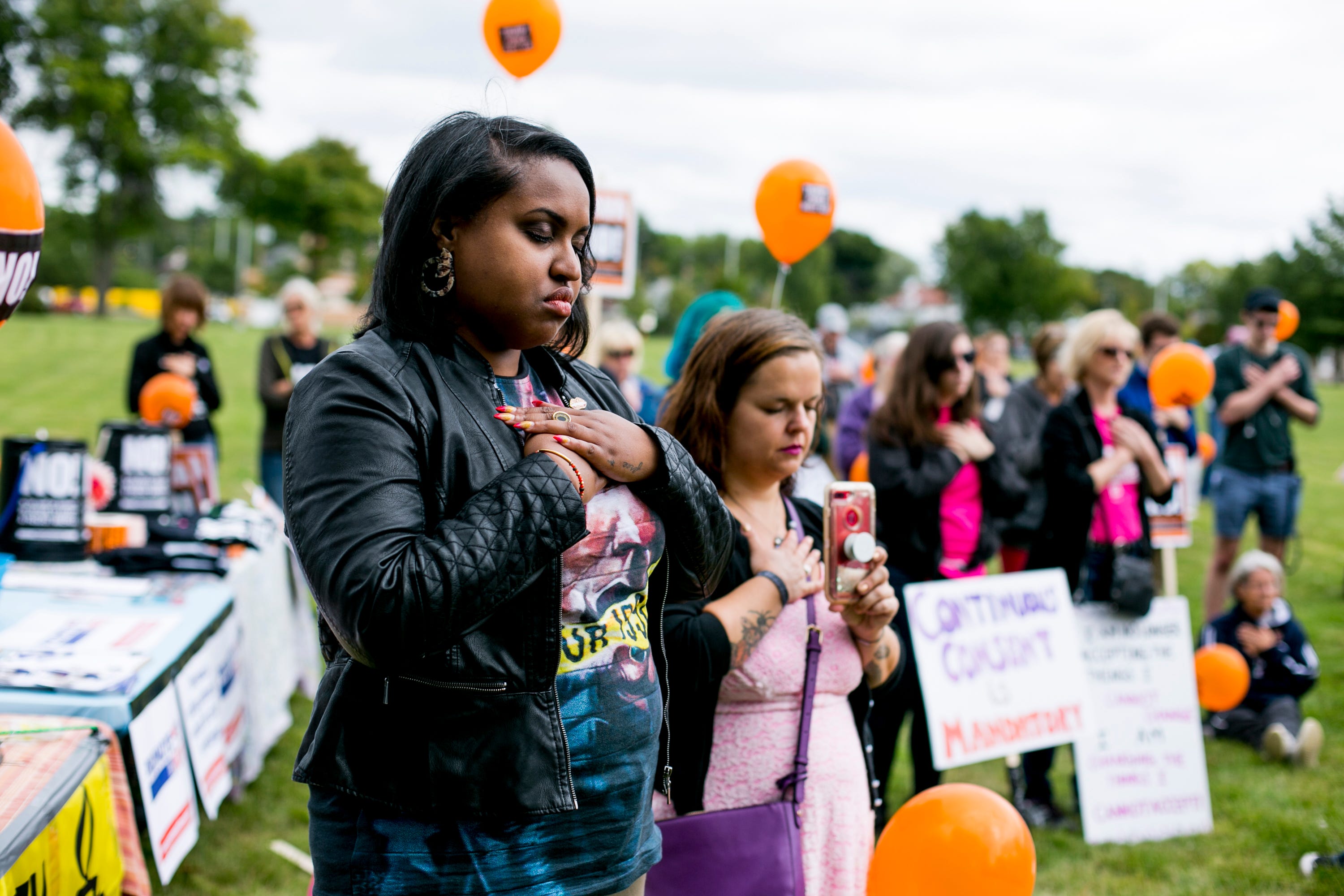 Nicole Denson, 33, of Detroit observes a moment of silence during the Slut Walk at Palmer Park.