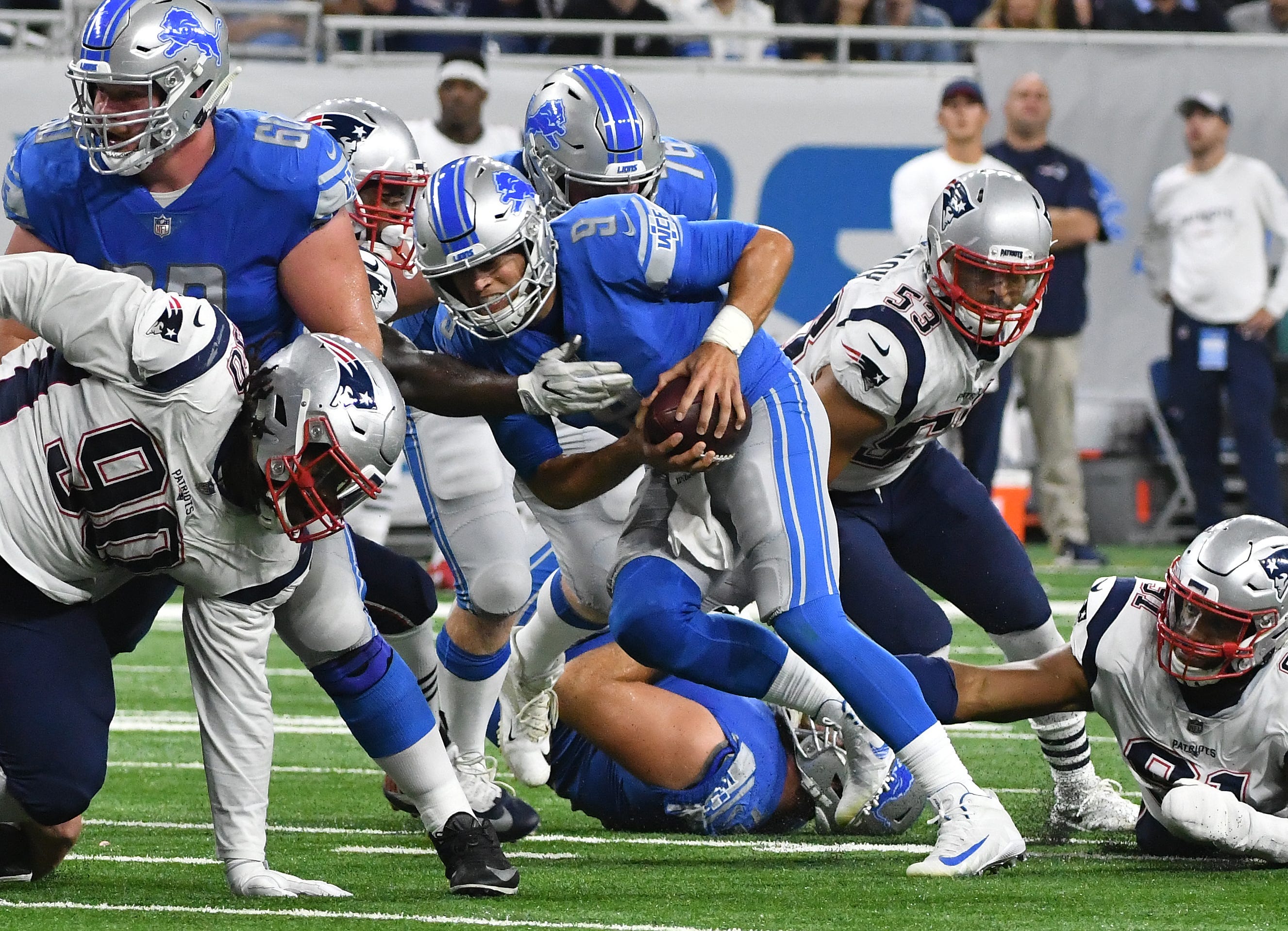 Lions quarterback Matthew Stafford scrambles out of pressure and throws a completion in the second quarter.