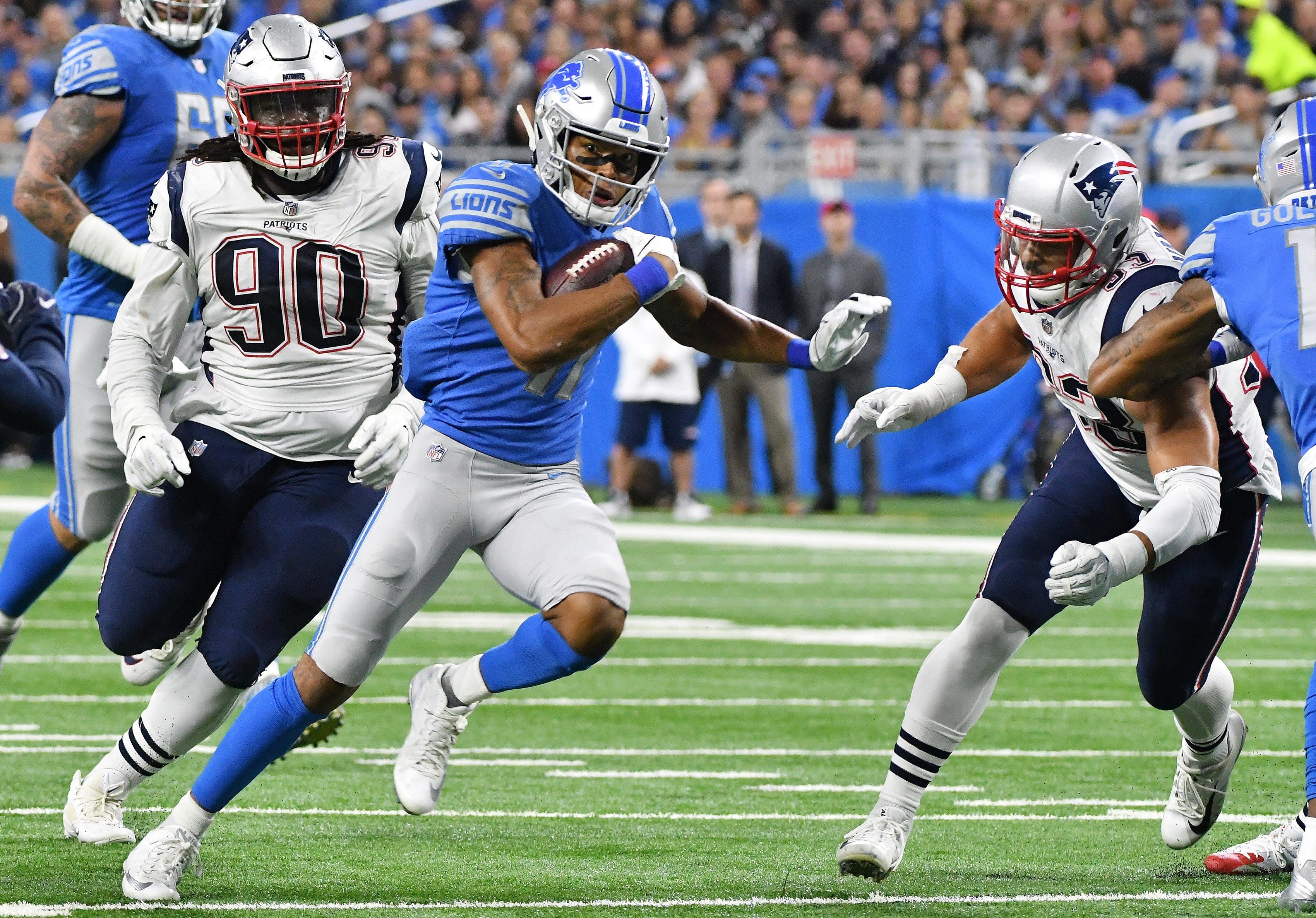 Patriots' Kyle Van Noy, right, comes in for an attempted tackle on Lions' Marvin Jones, Jr. running for a first down in the first half.