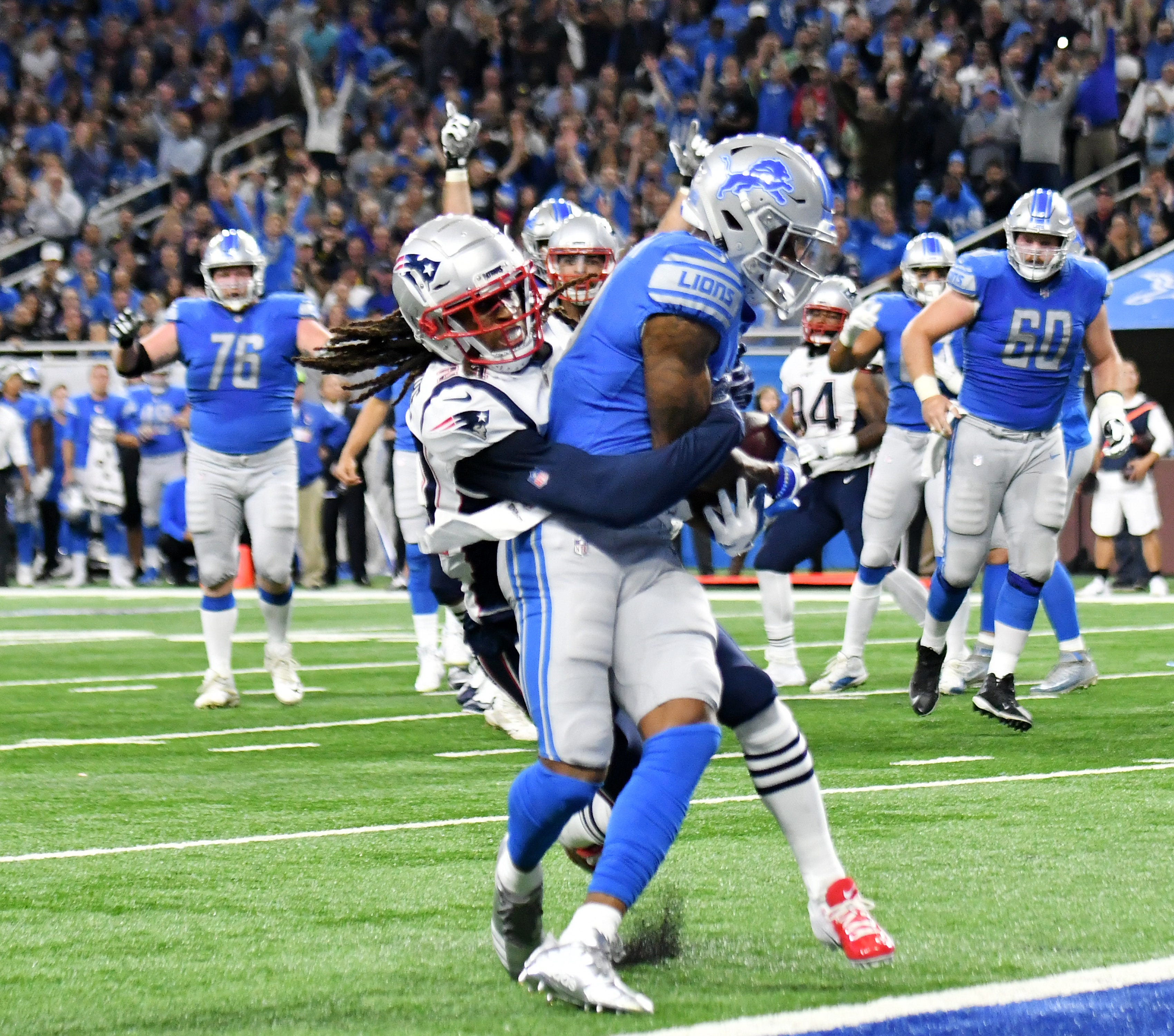 Patriots ' Stephon Gilmore, left, tries to tackle Lions ' Kenny Golladay at the goal line in the second quarter. The ball was initially ruled short of the goal line, but after a challenge and review the call was overturned and ruled a touchdown.