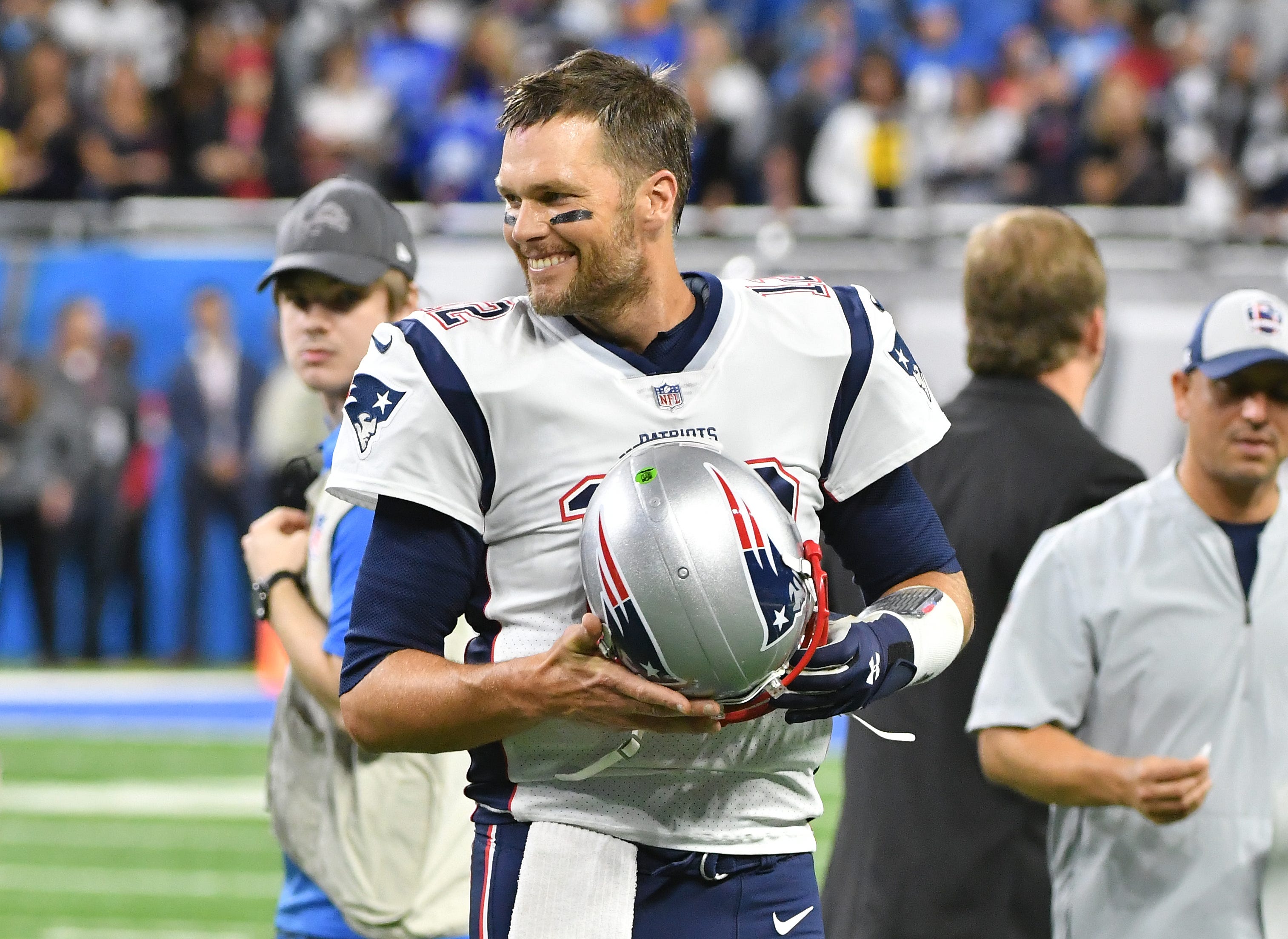 Patriots quarterback Tom Brady smiles as he walks off the field after warm-ups.