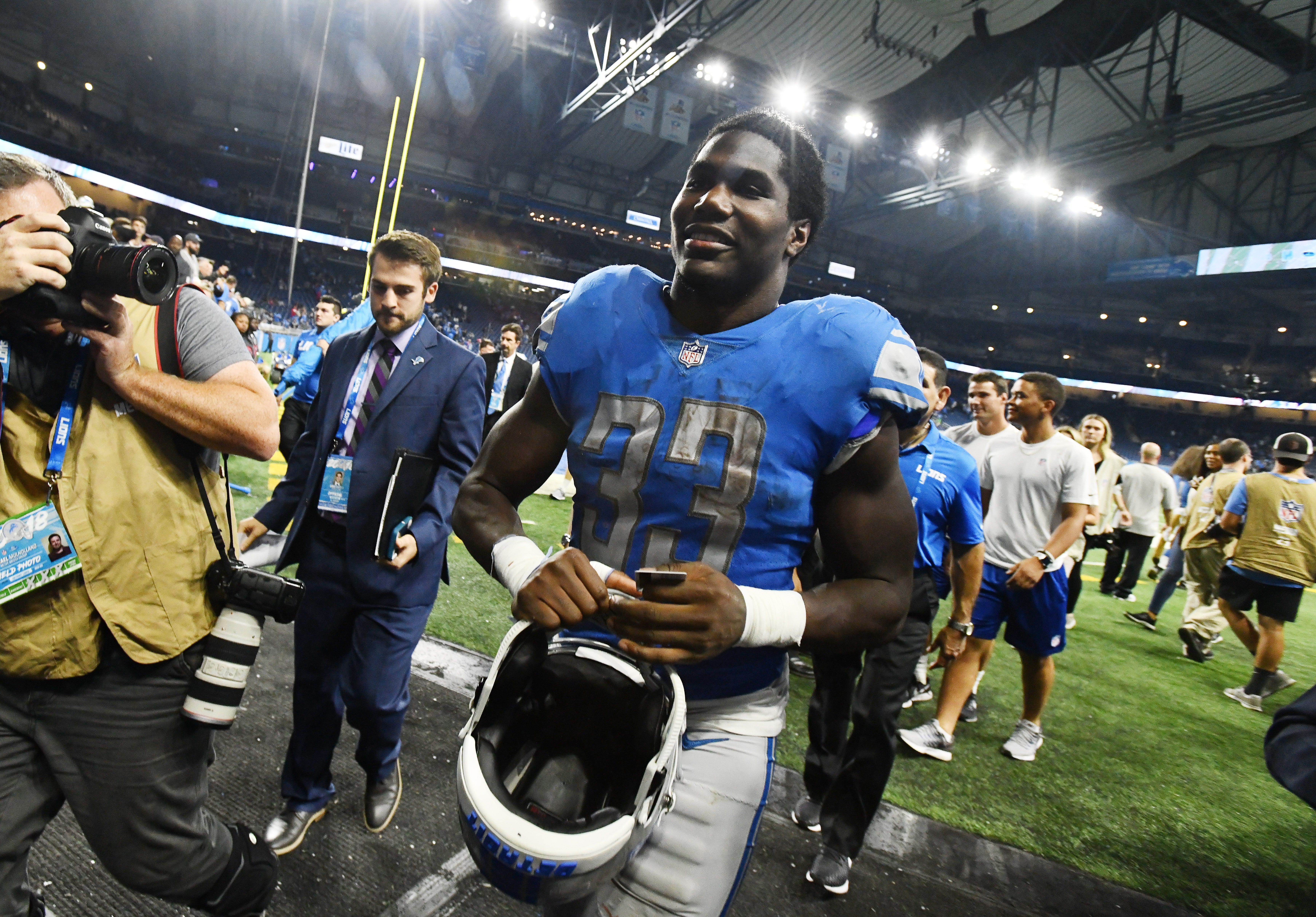 Running back Kerryon Johnson, leaving the field, ends the Detroit Lions ' 100-yard rusher drought at 70 games in the 26-10 victory over the Patriots.