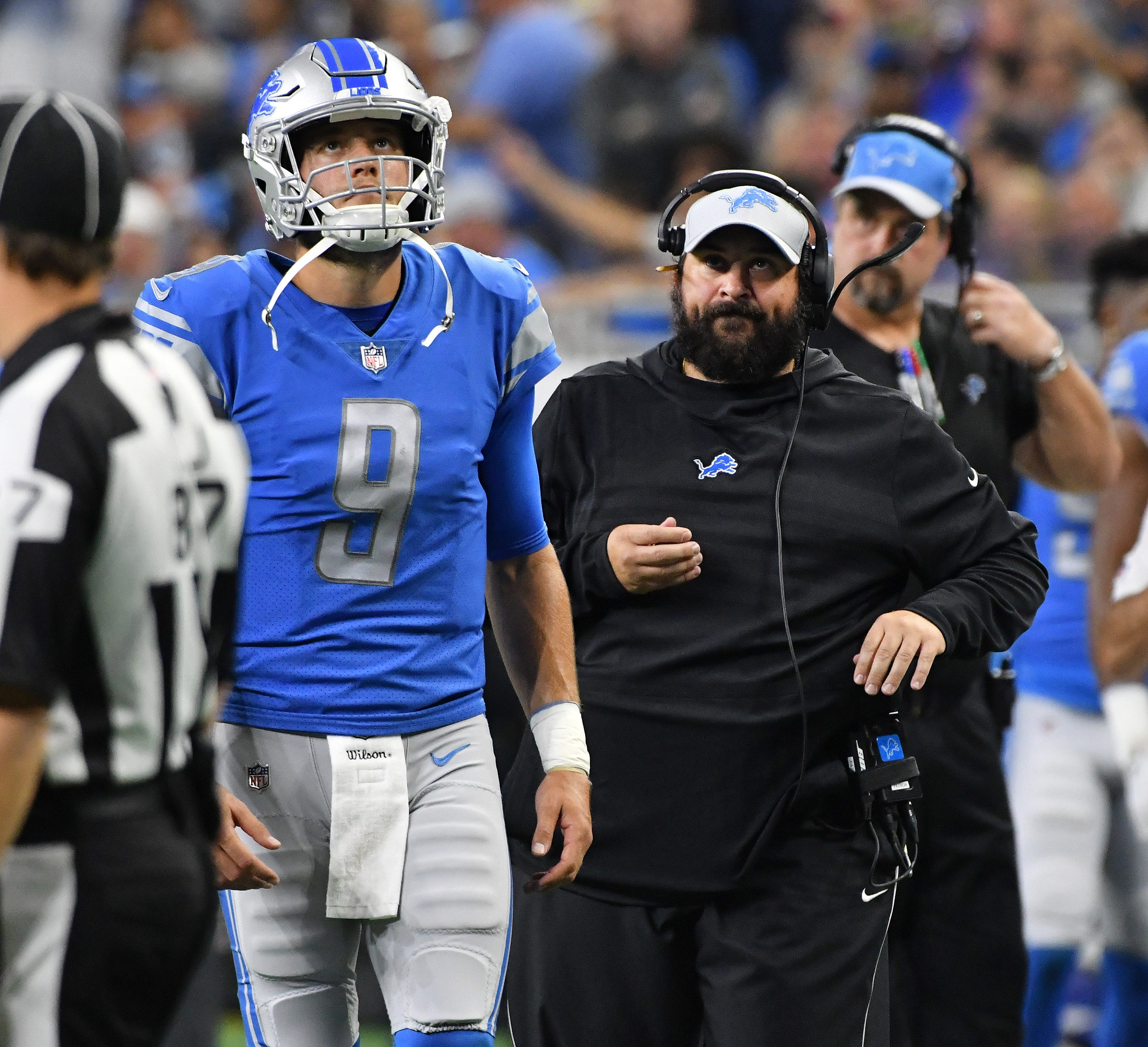 Lions quarterback Matthew Stafford and head coach Matt Patricia watch a replay of the challenged call on a goal-line play in the second quarter.